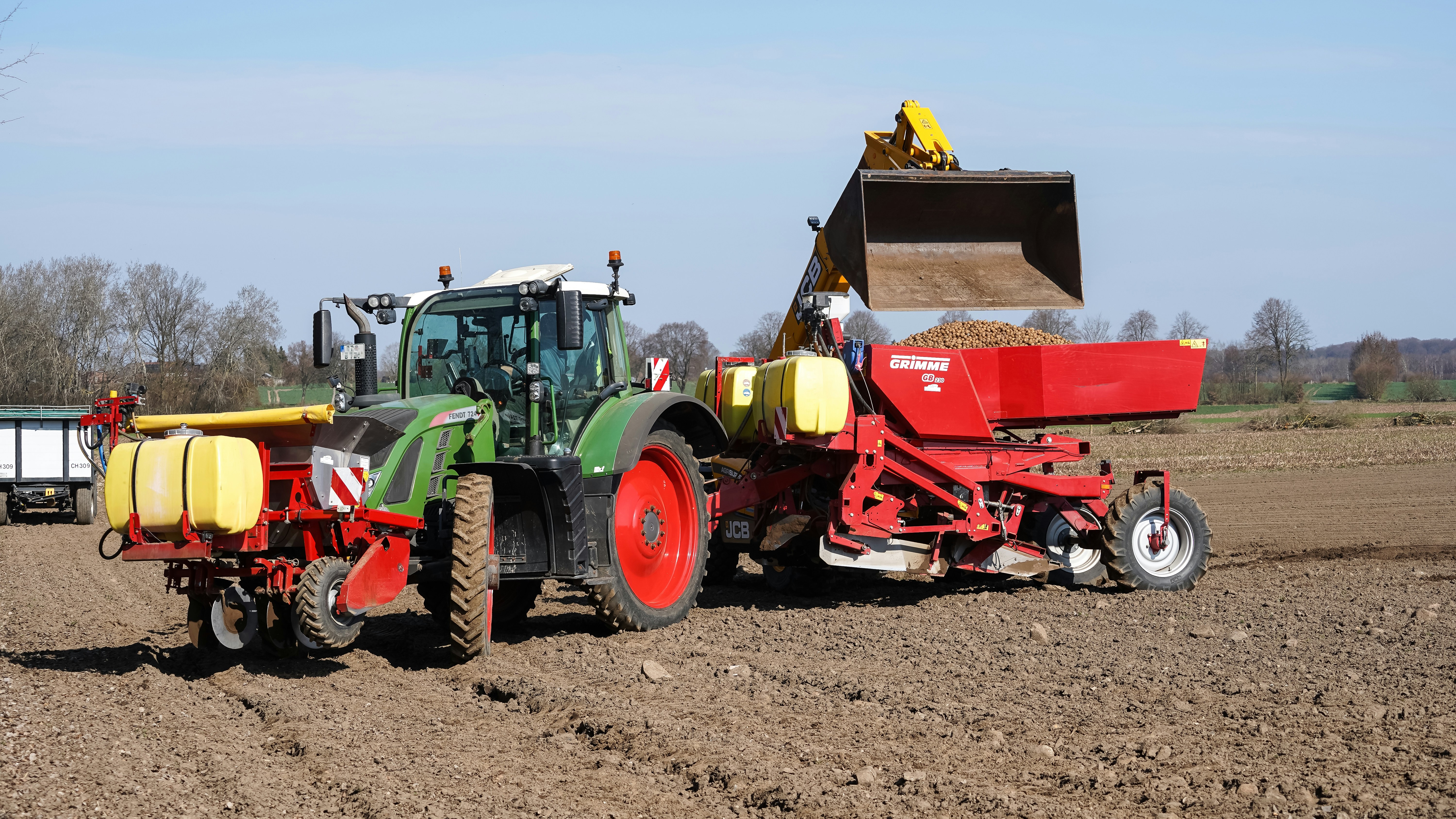 Tractor planting seeds in a field
