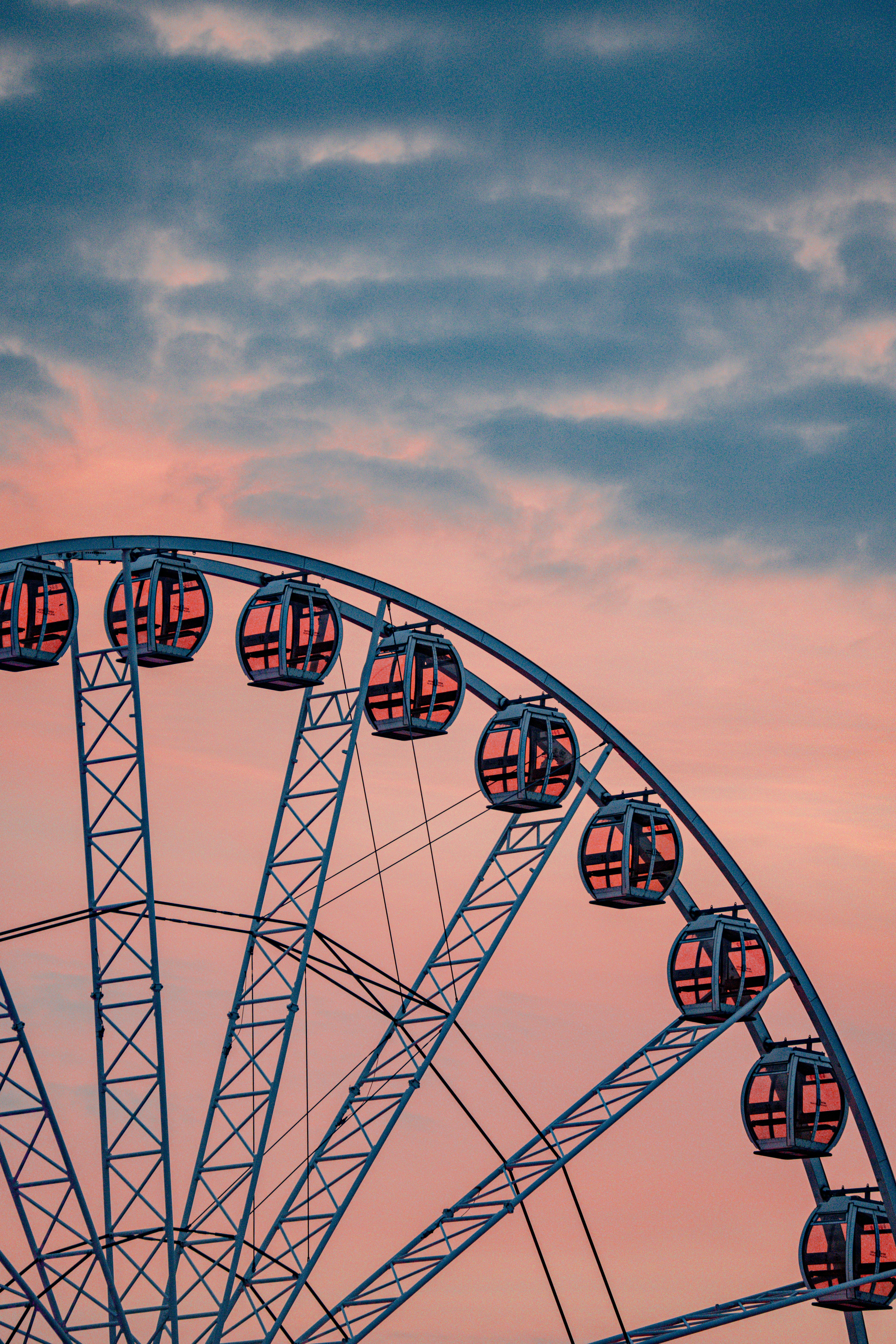 Ferris wheel against a pastel sunset sky