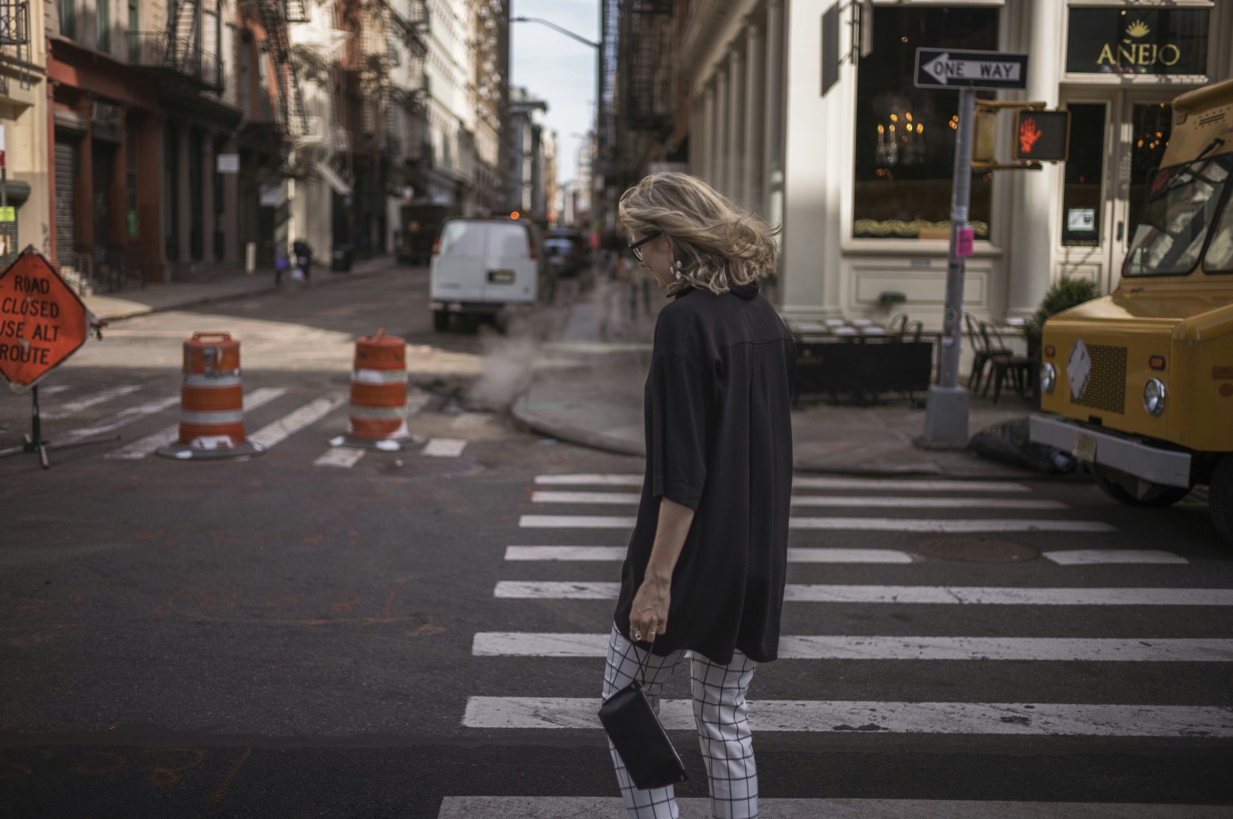 Woman crossing a city street at a crosswalk