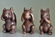 Three bronze squirrel figurines covering their eyes, ears, and mouth.
