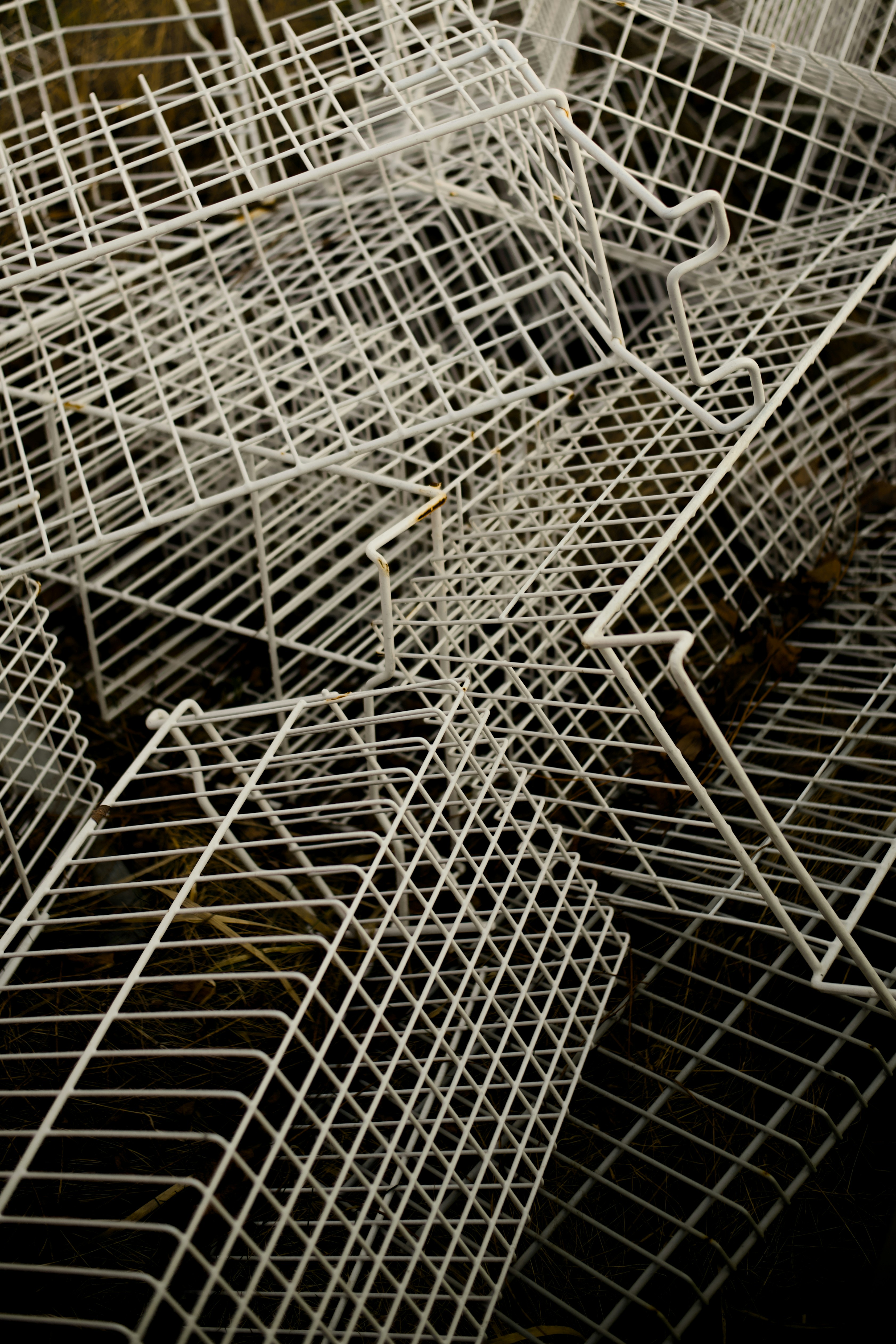 Pile of white wire shelves stacked shelves