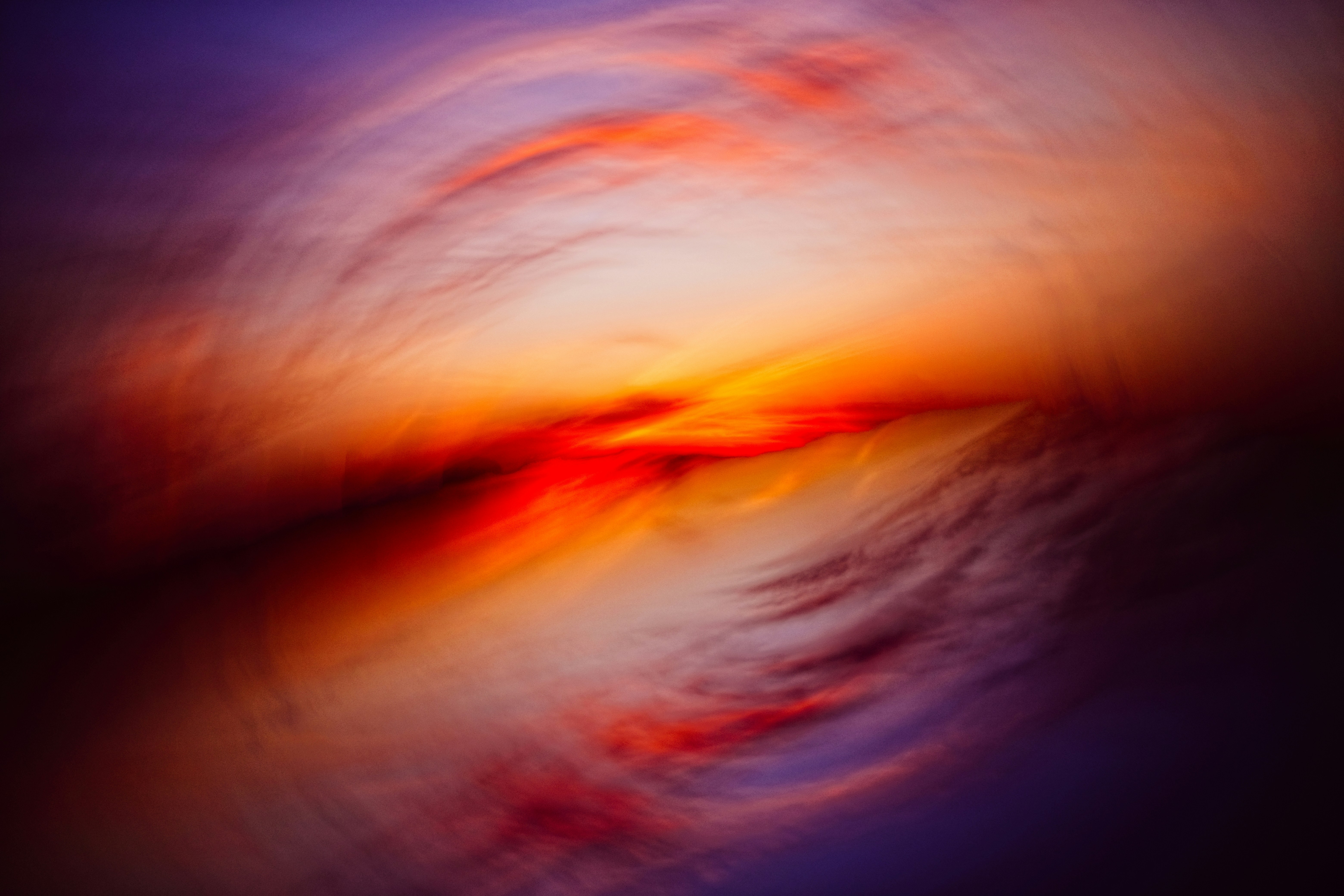Abstract swirling clouds at sunset with vibrant colors