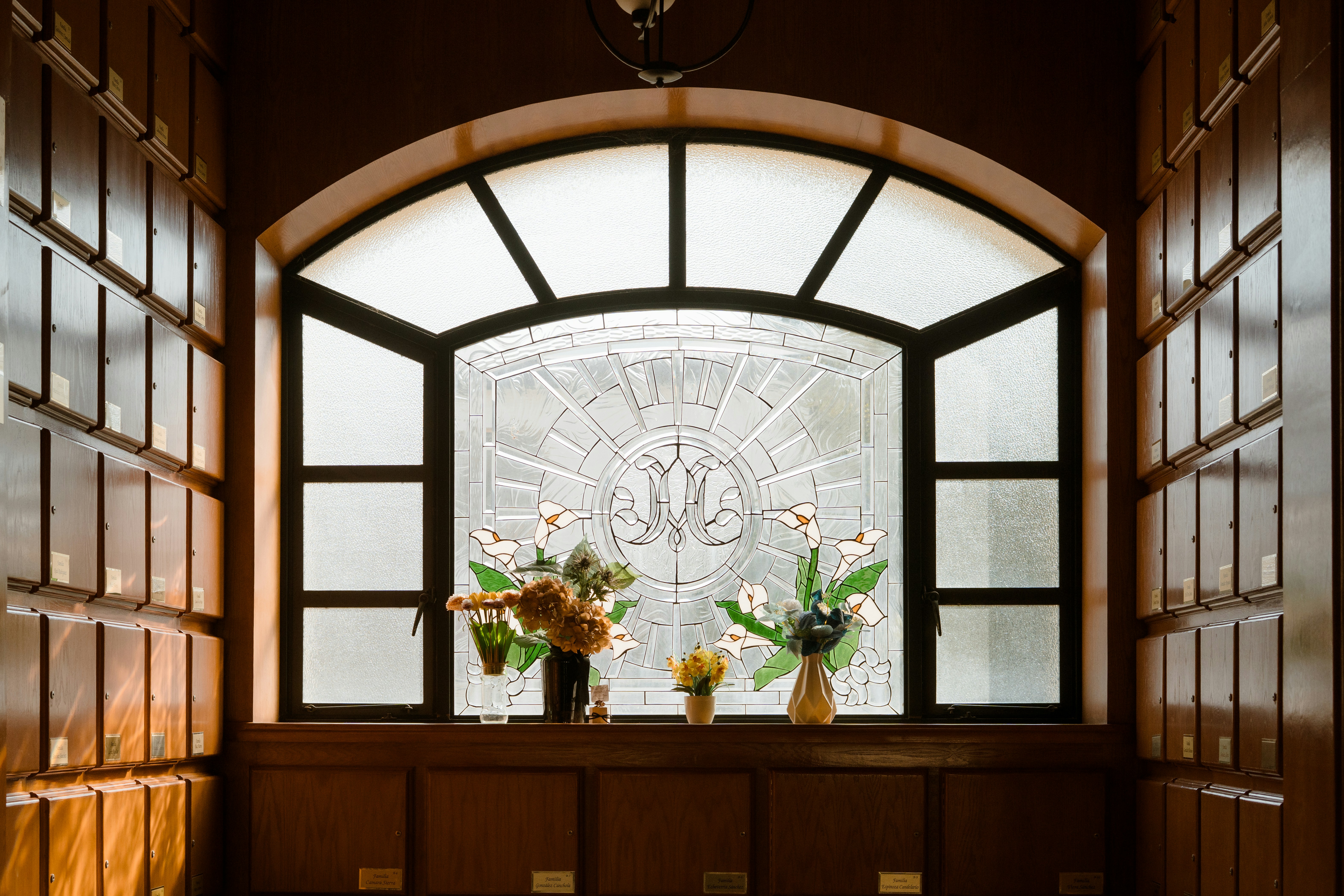 Verziertes Fenster mit Blumenarrangements auf der Fensterbank