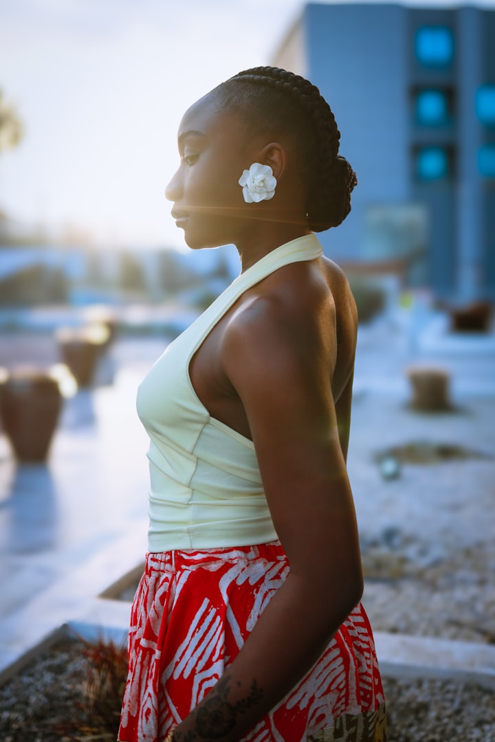 A young person in profile with braided hair, soft natural light, anonymized framing