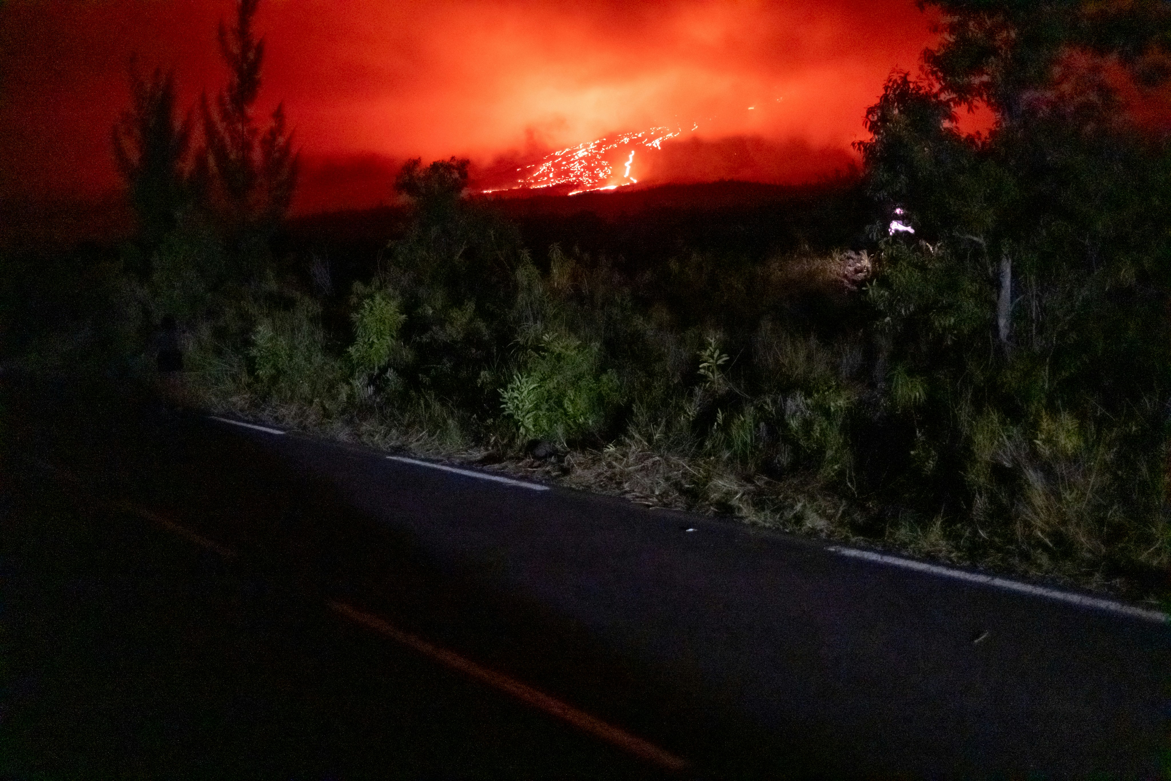Wildfire raging on a hillside at night