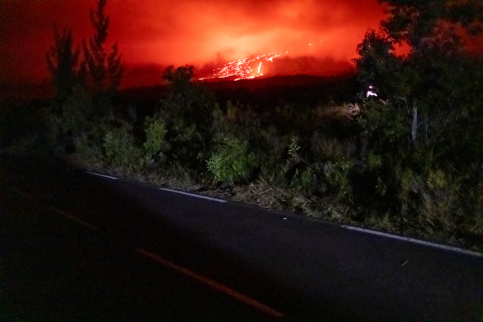 A wildfire burning near a hillside