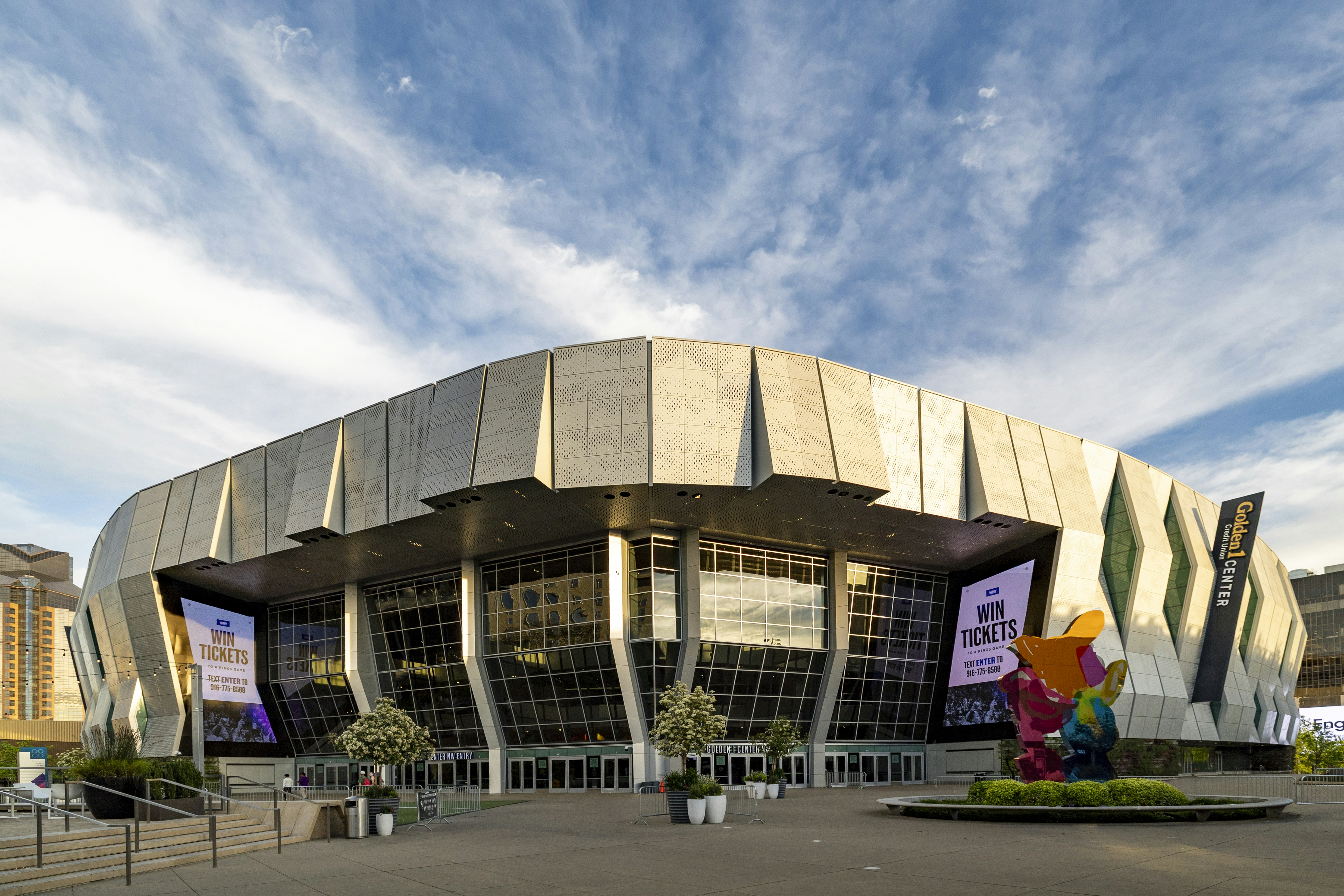 Modern arena building with large glass windows and geometric facade