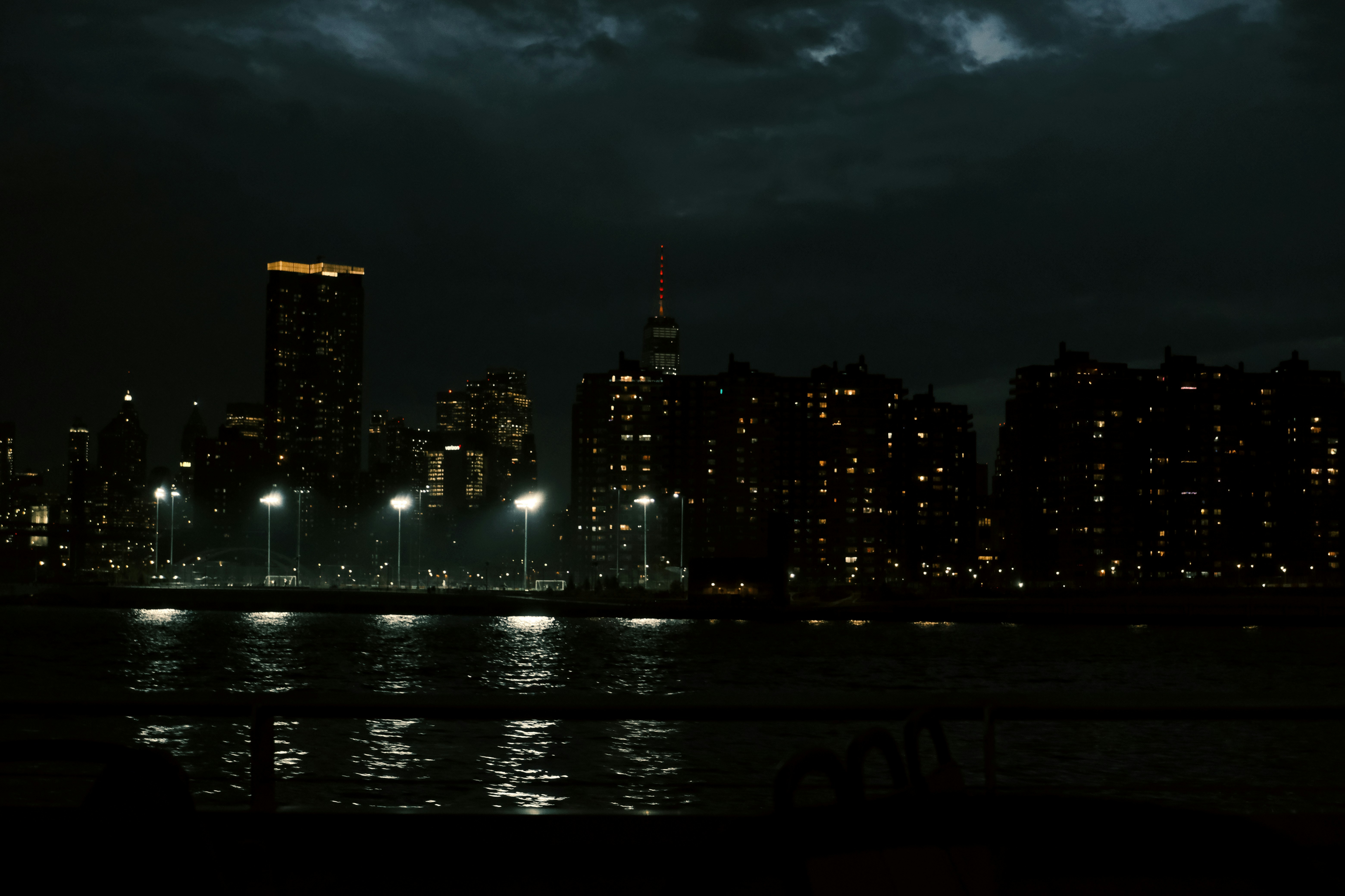 City skyline at night with lights reflecting on water