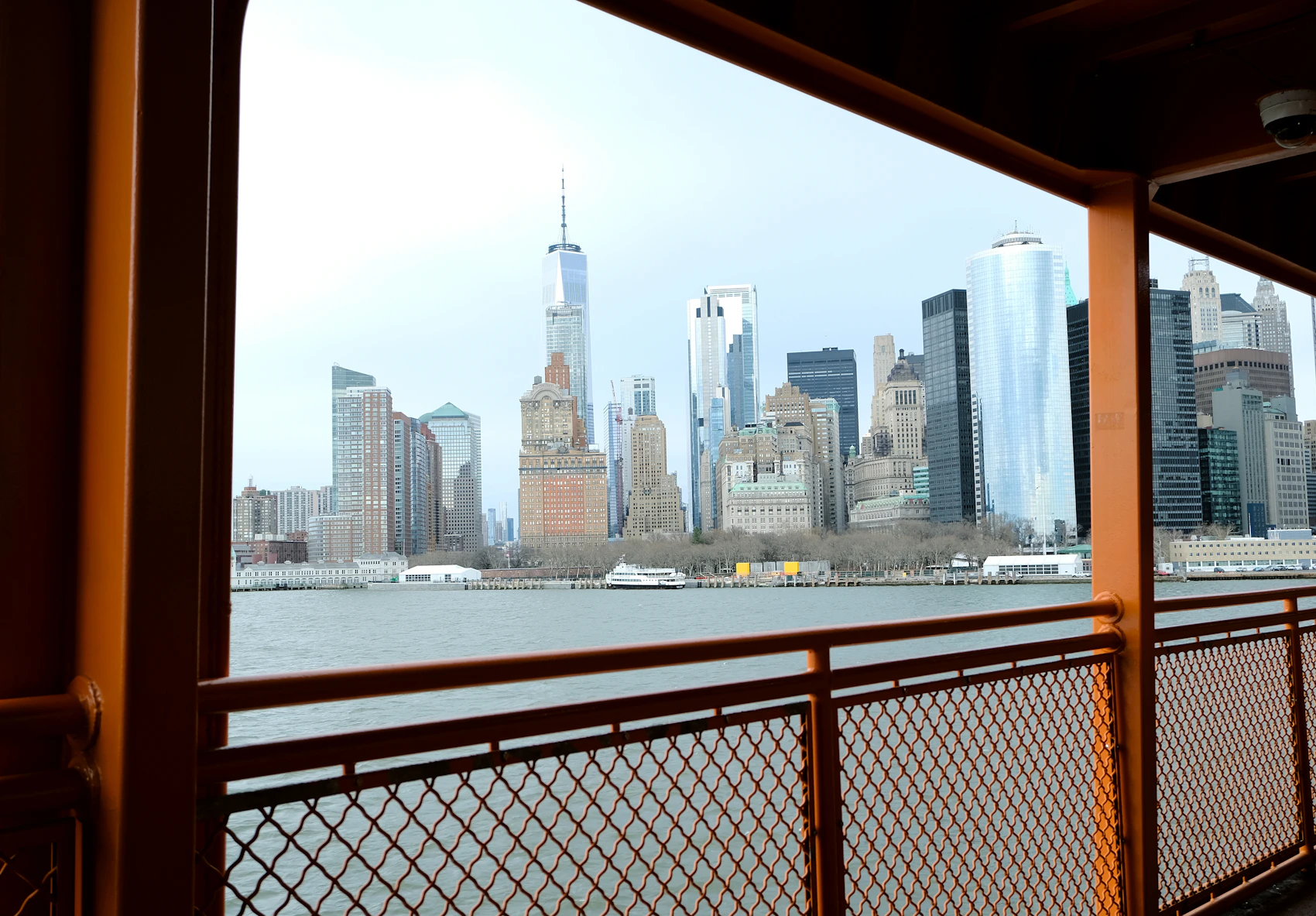 A city skyline seen across the water from a passenger ferry