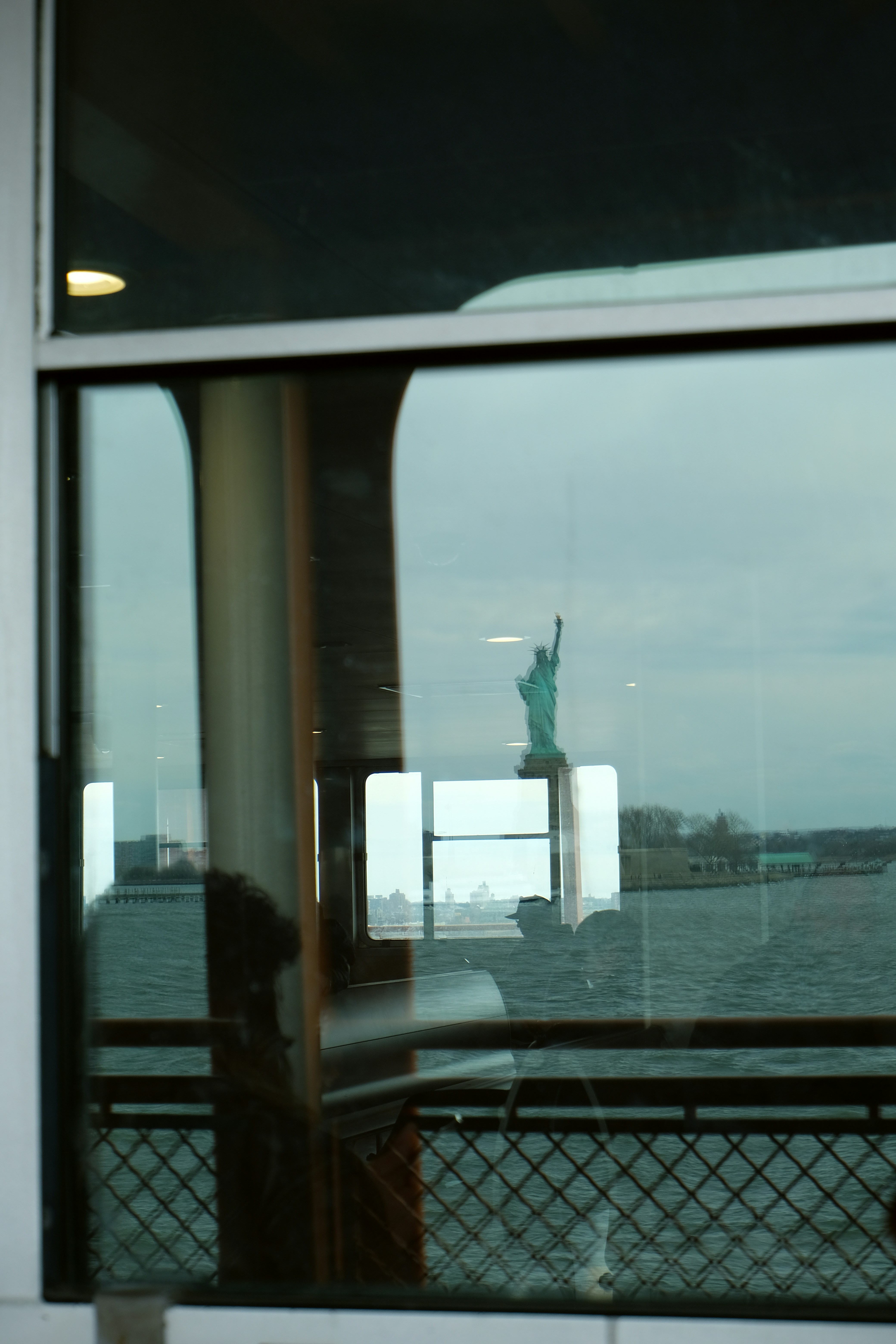 Statue of liberty reflected in a window