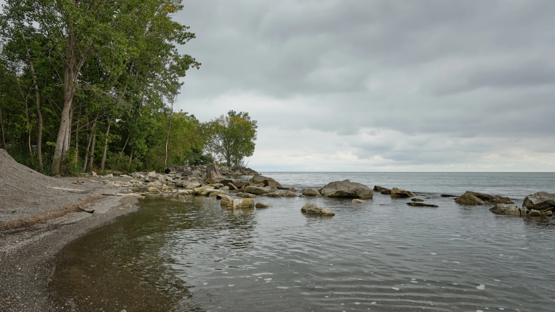 A Rocky Ontario Shoreline Beneath An Overcast Sky