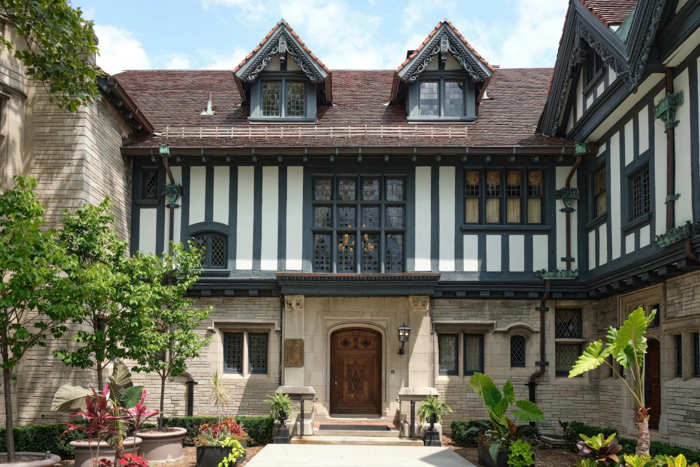 A tudor-style home with steep gables and leaded windows