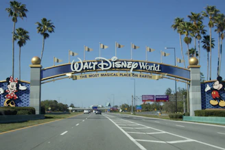 Walt disney world entrance with mickey and minnie mouse statues.