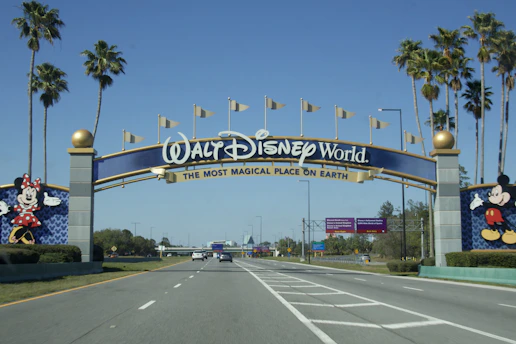 Walt disney world entrance with mickey and minnie mouse statues.