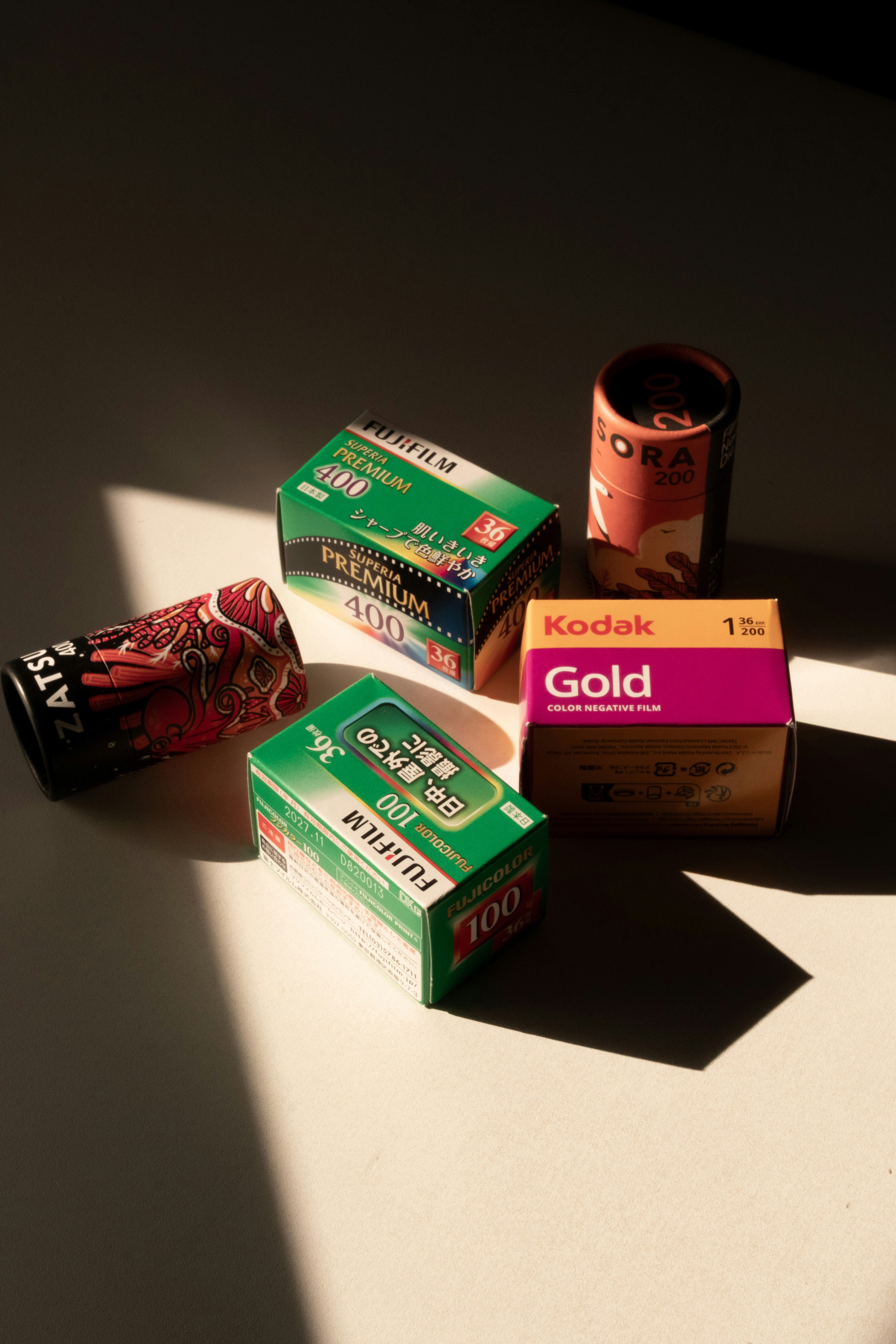 Several rolls of photographic film on a white surface.