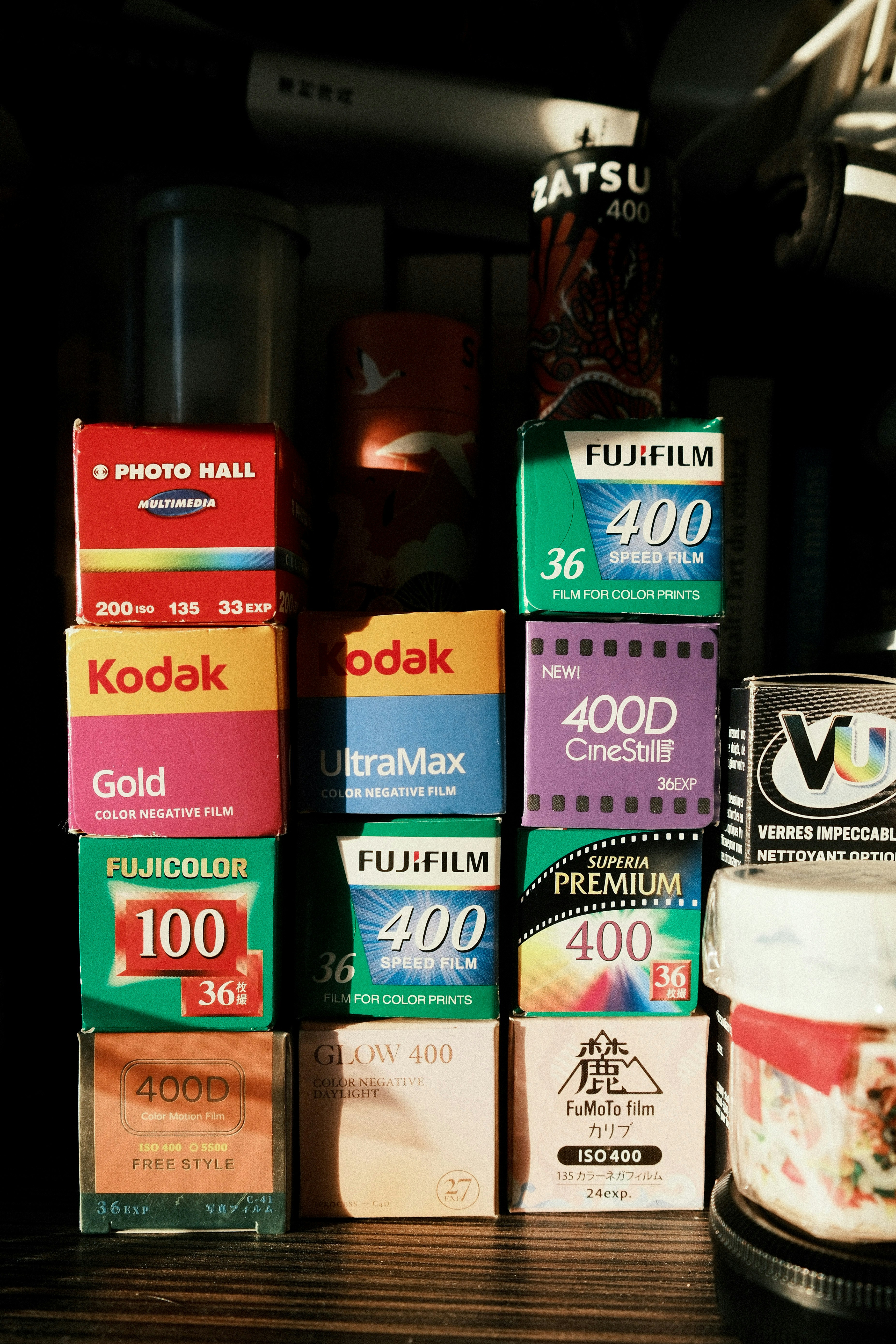 Various film boxes stacked on a shelf.