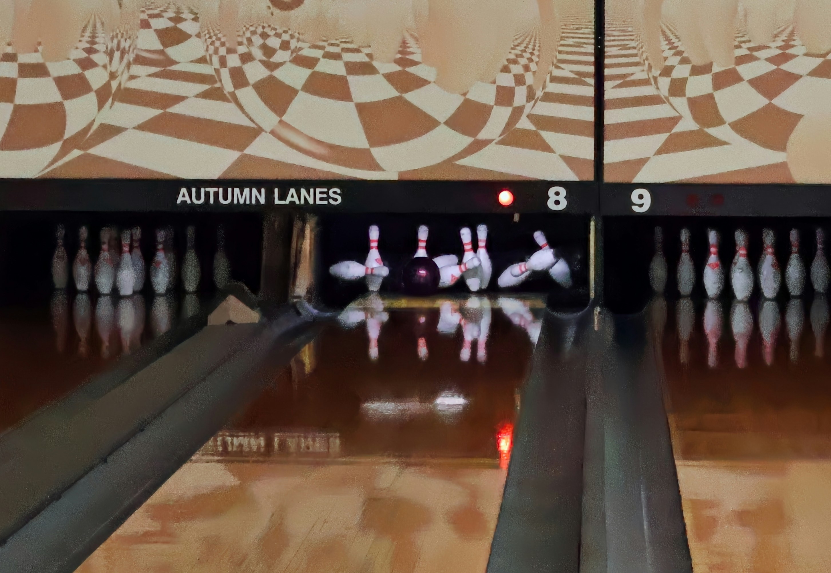 Bowling pins scattered after a strike on autumn lanes.