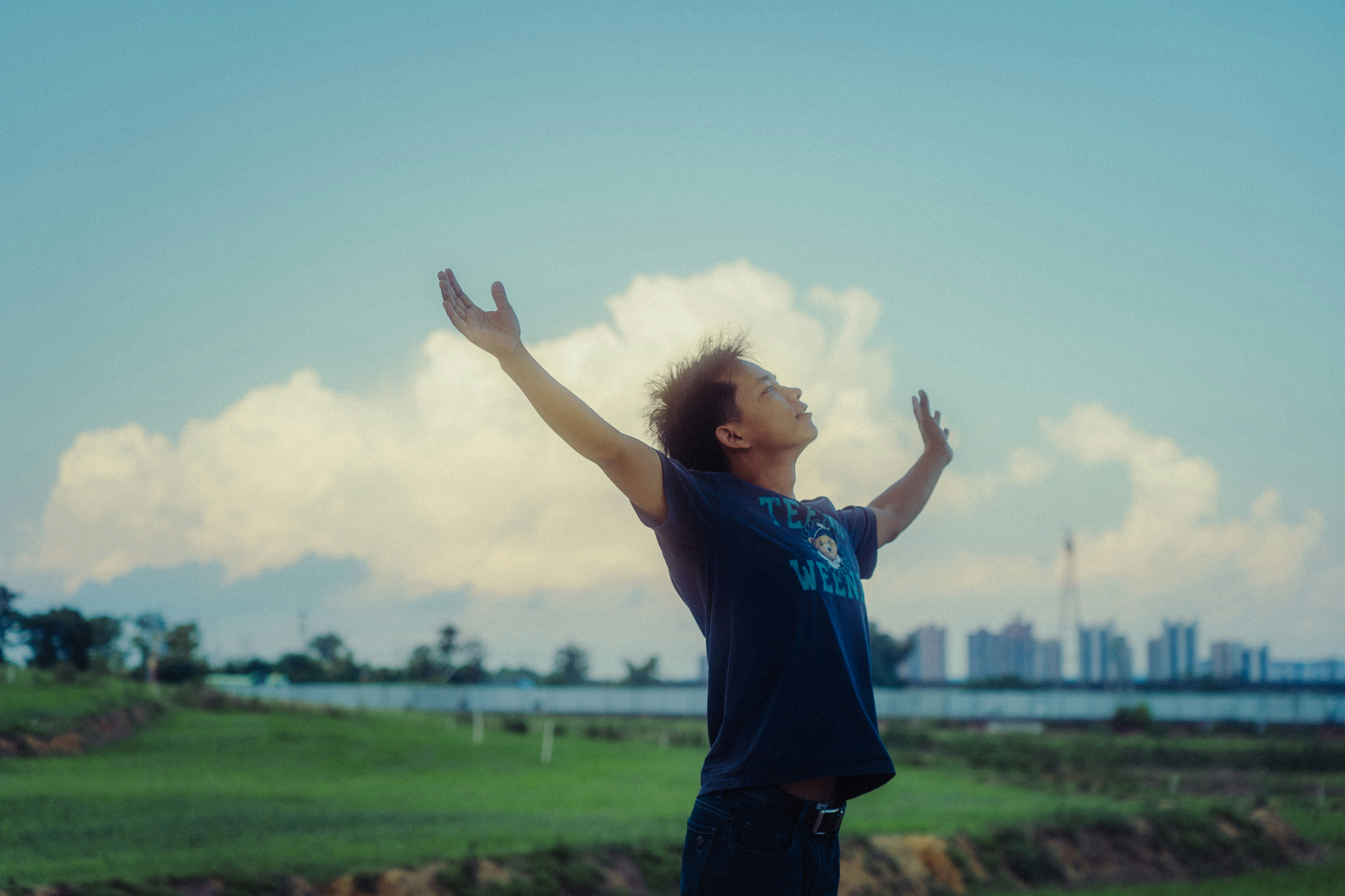Man with arms raised to the sky