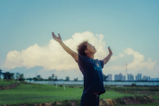 Man with arms raised to the sky