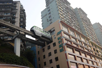 Monorail train passes through a building in a city.