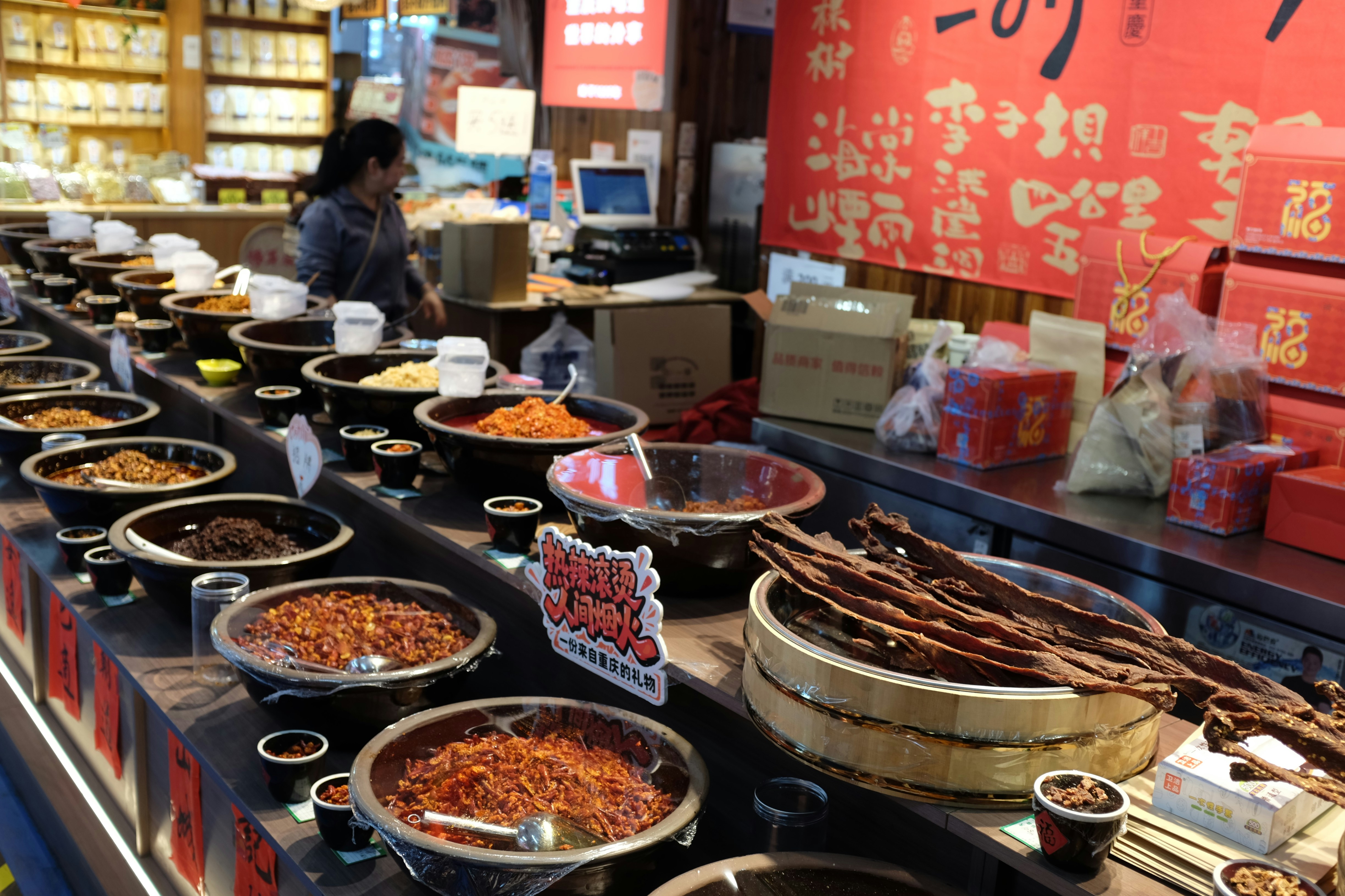 Bowls of spices and dried goods displayed in a market.