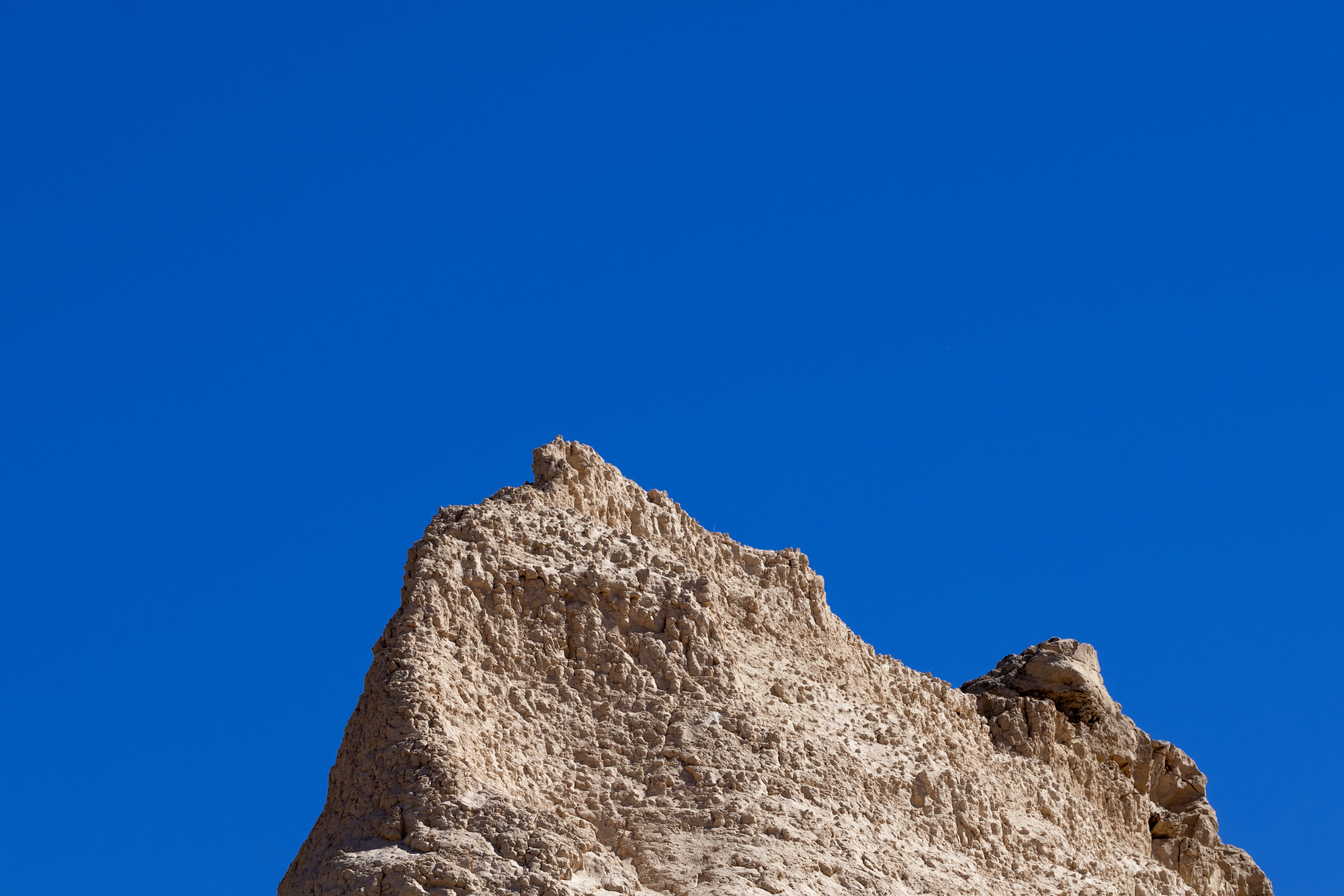 Jagged rock formation against a clear blue sky
