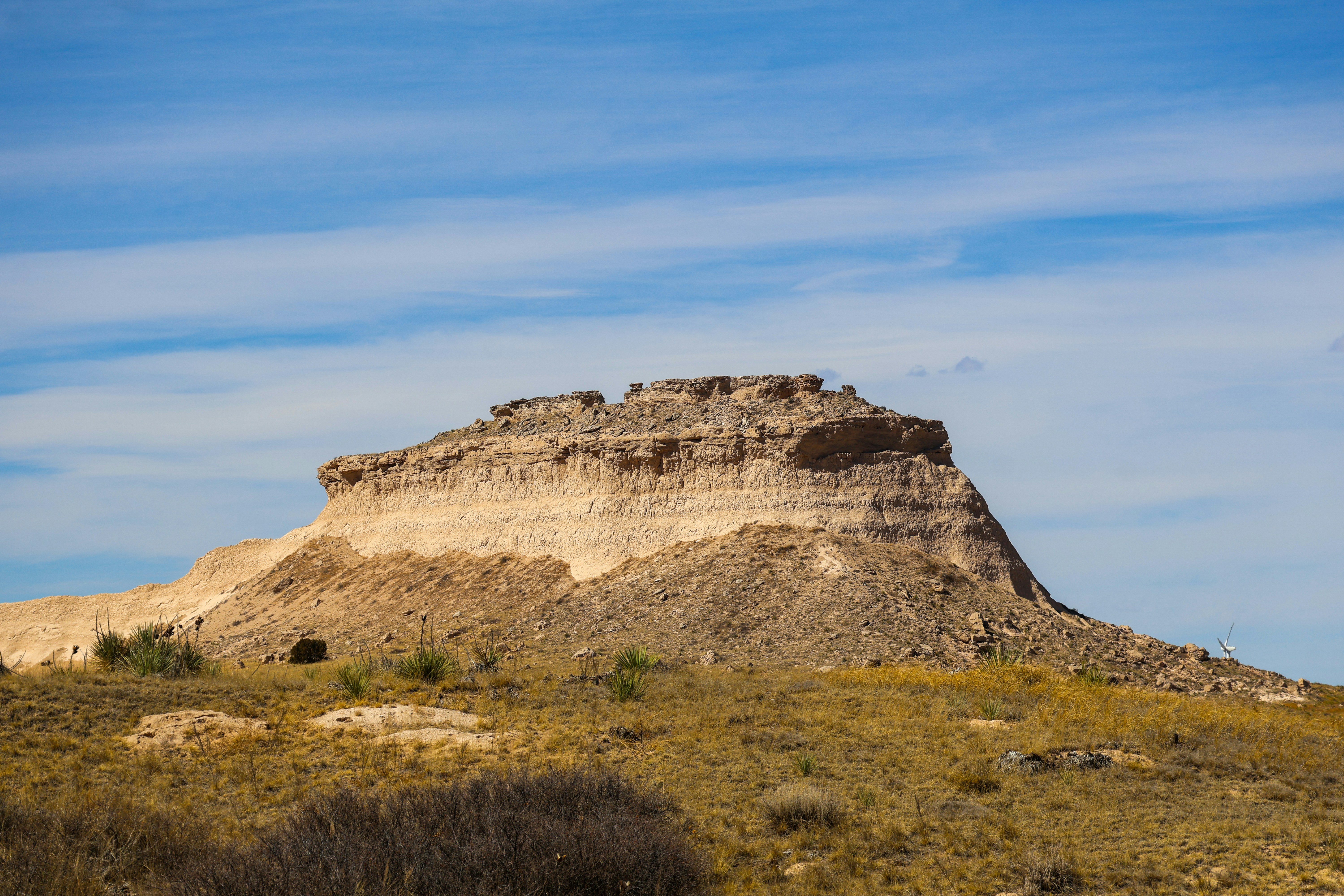 A large rock formation under a blue sky