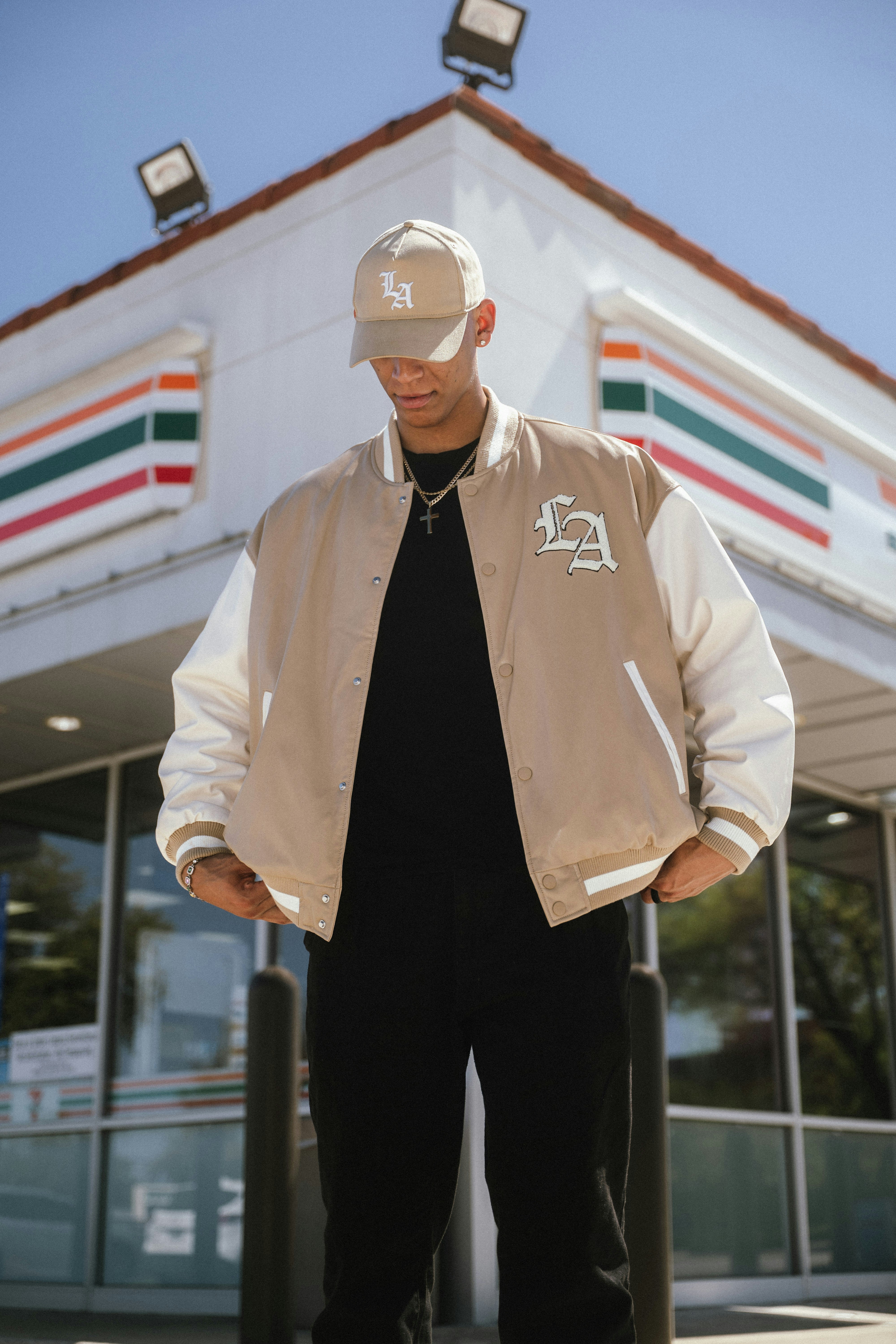 Man wearing a tan jacket and baseball cap