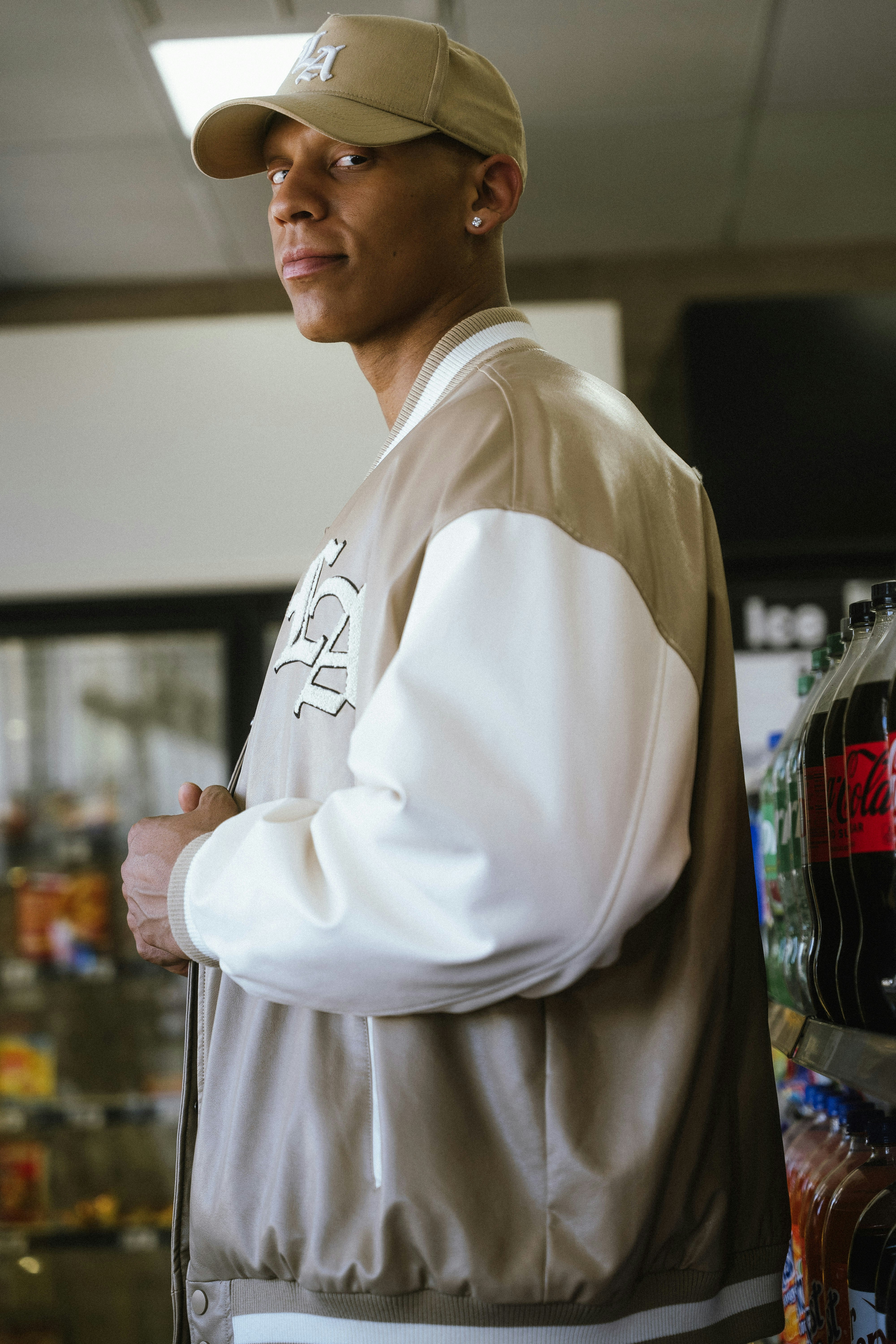 Man in baseball cap and varsity jacket
