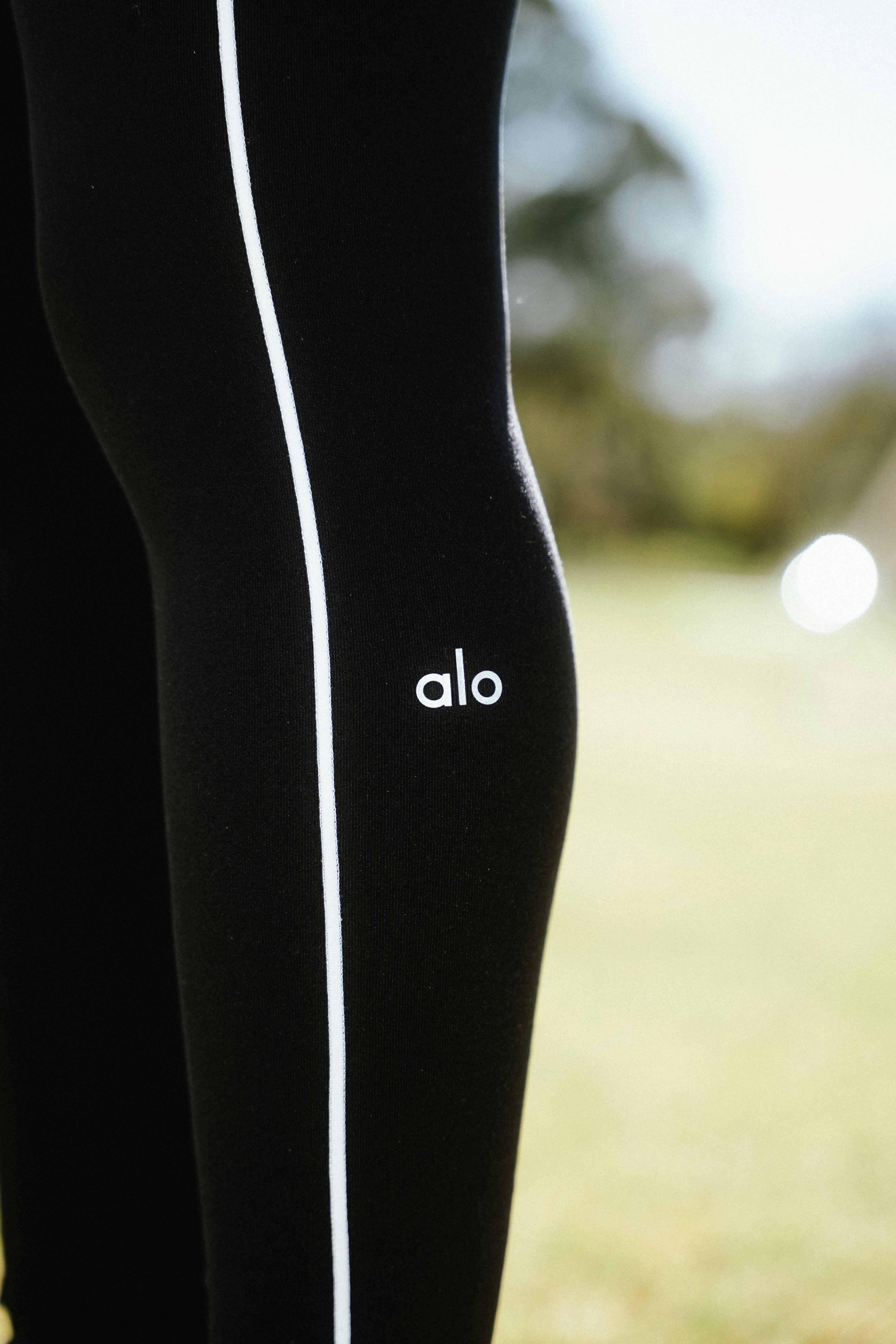 Black leggings with white stripe and logo detail.