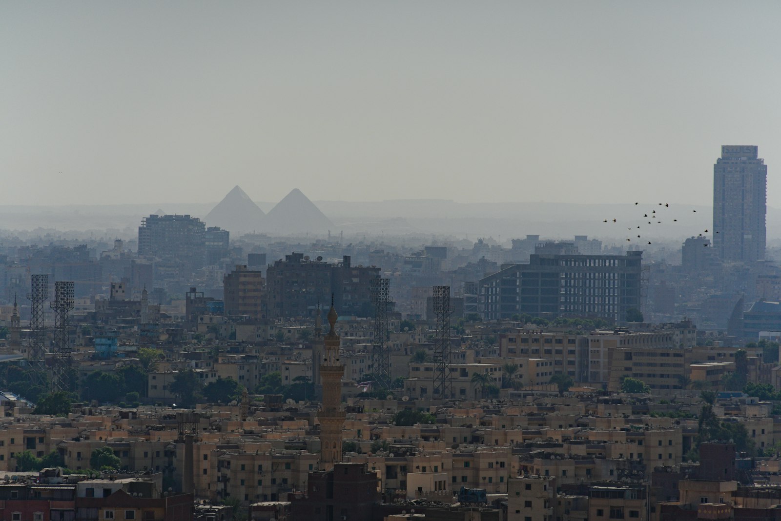 The pyramids rising over the hazy Cairo skyline