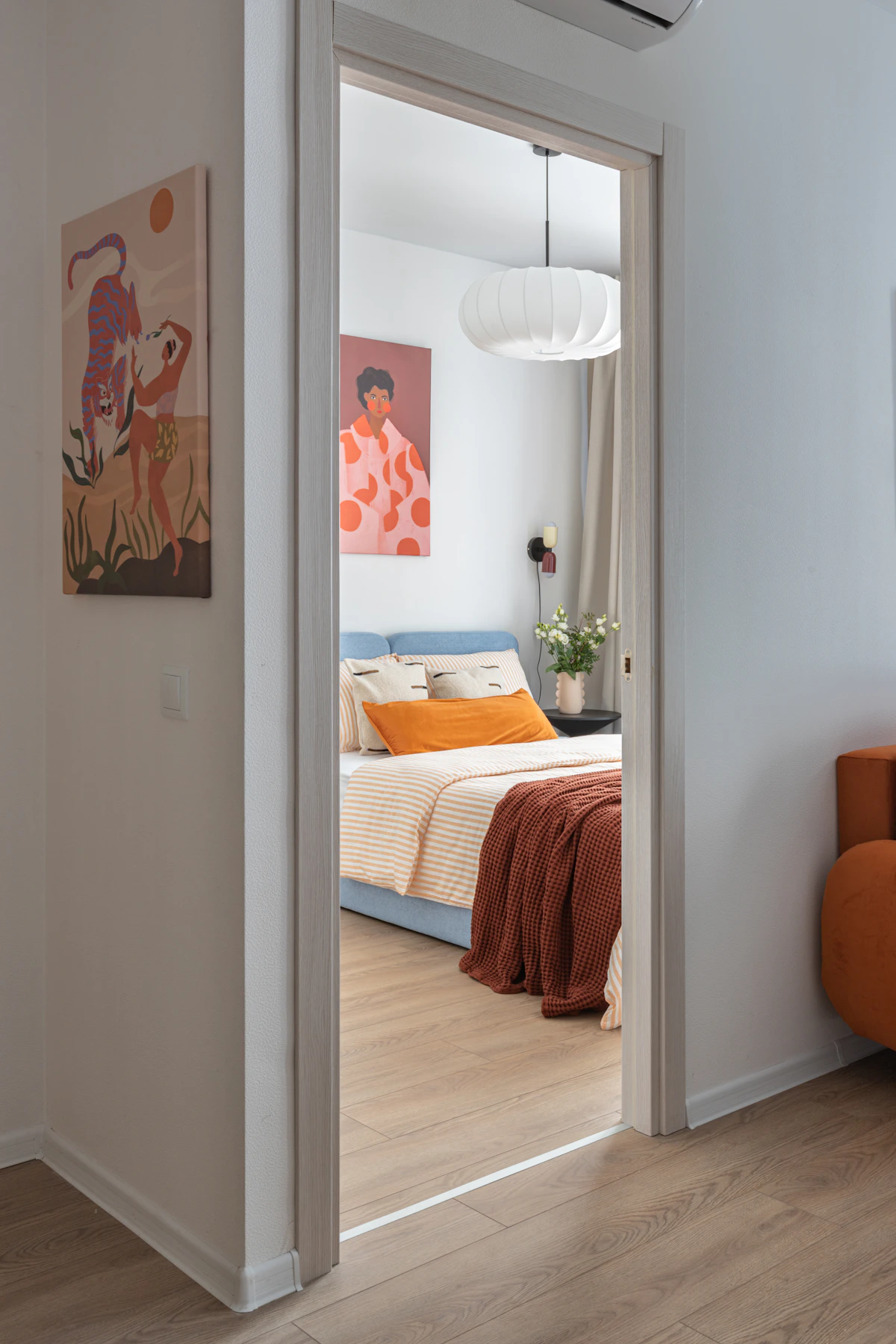 Modern bedroom with colorful artwork and coordinated bedding showing a modern preppy direction