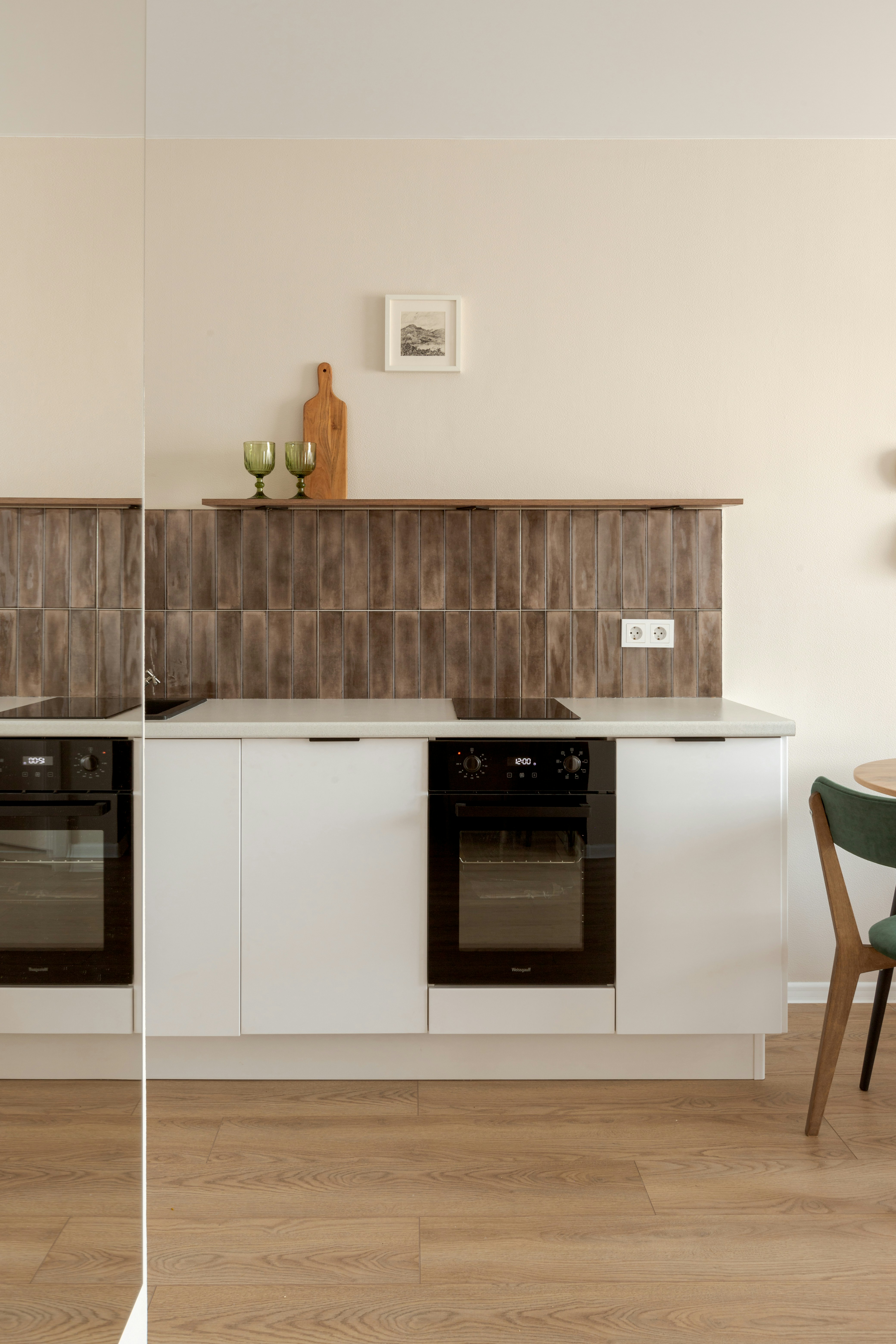 Modern white kitchen with dark tiled backsplash
