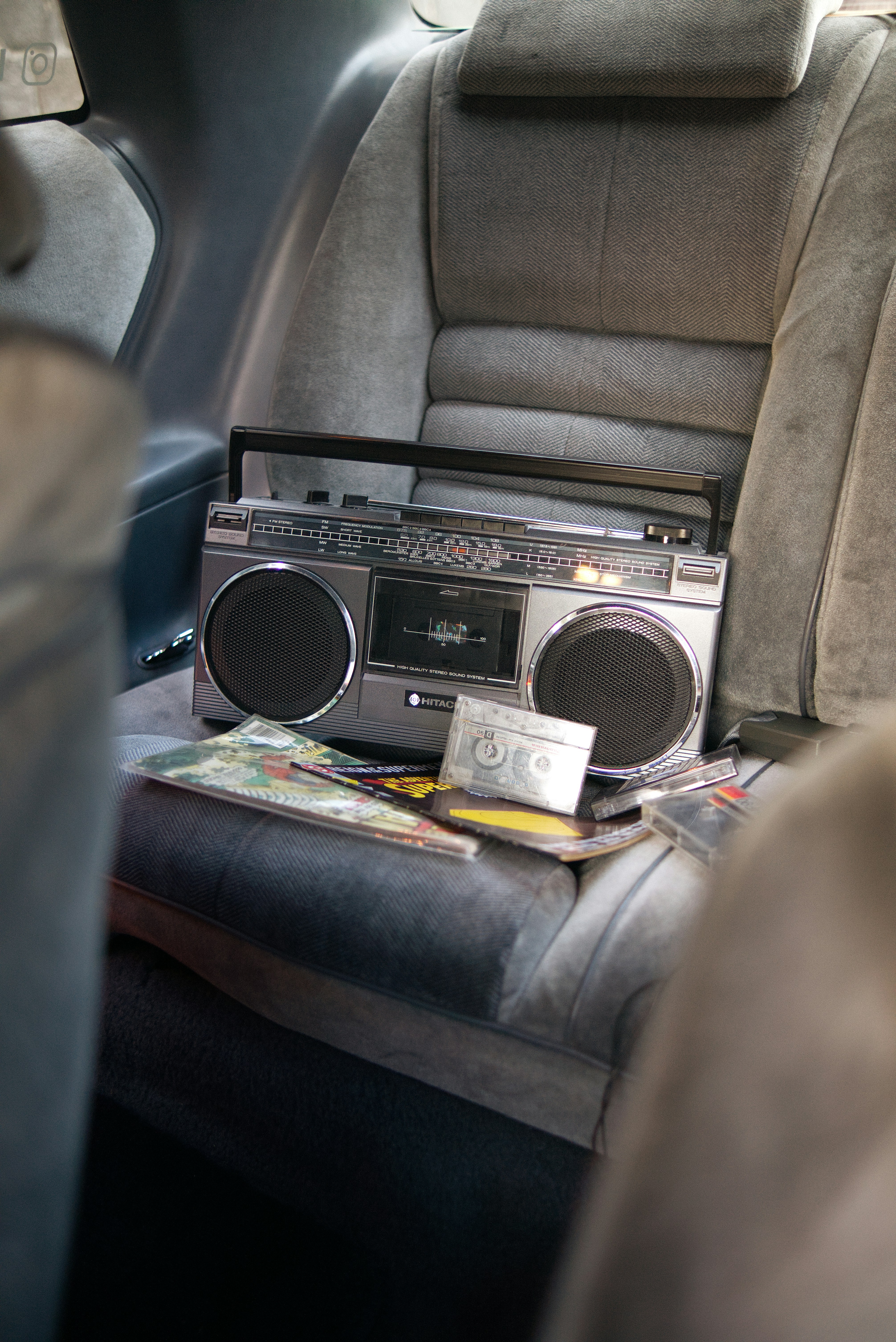 Retro boombox and cassette tapes on a car seat