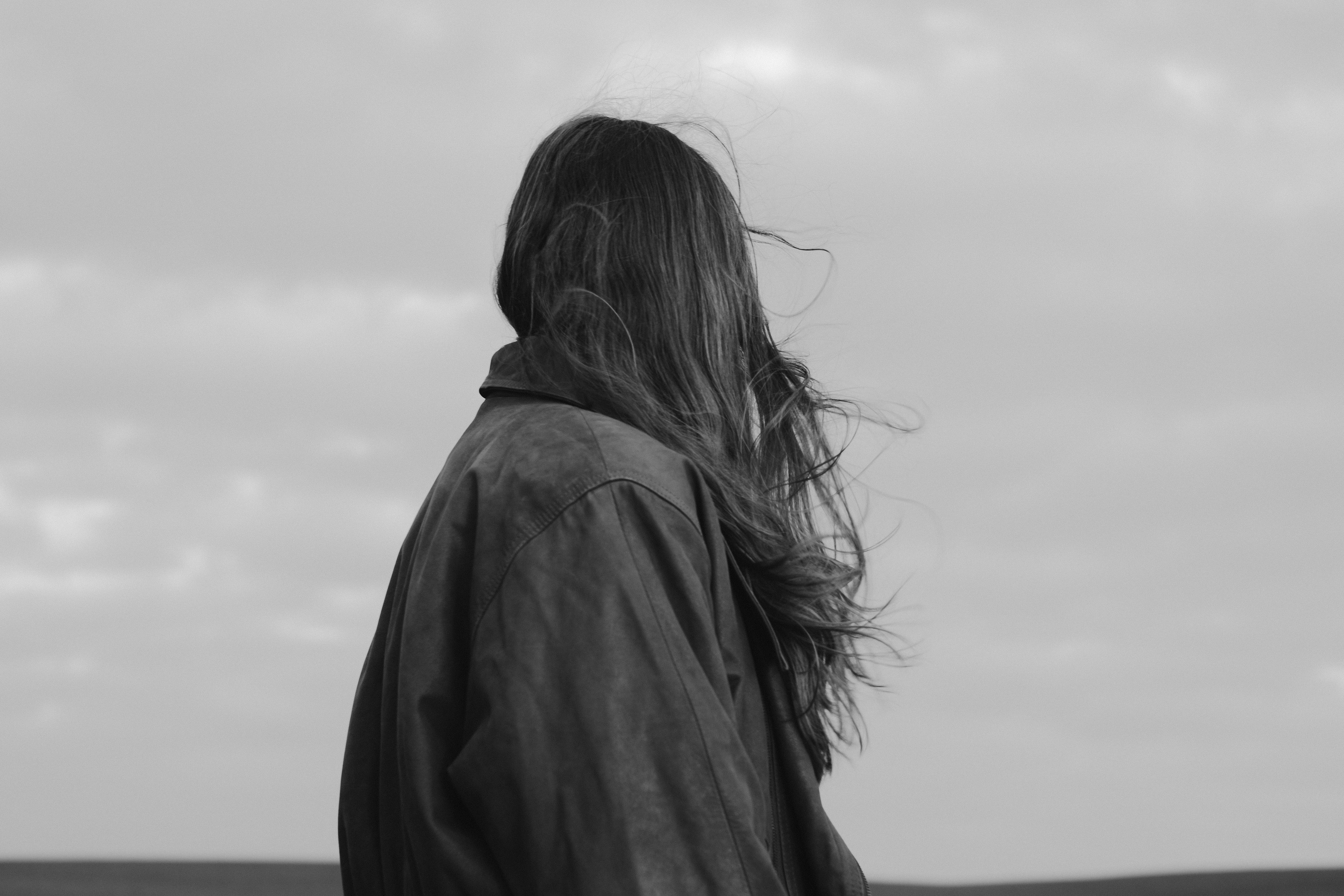 Woman with long hair looking out at the horizon