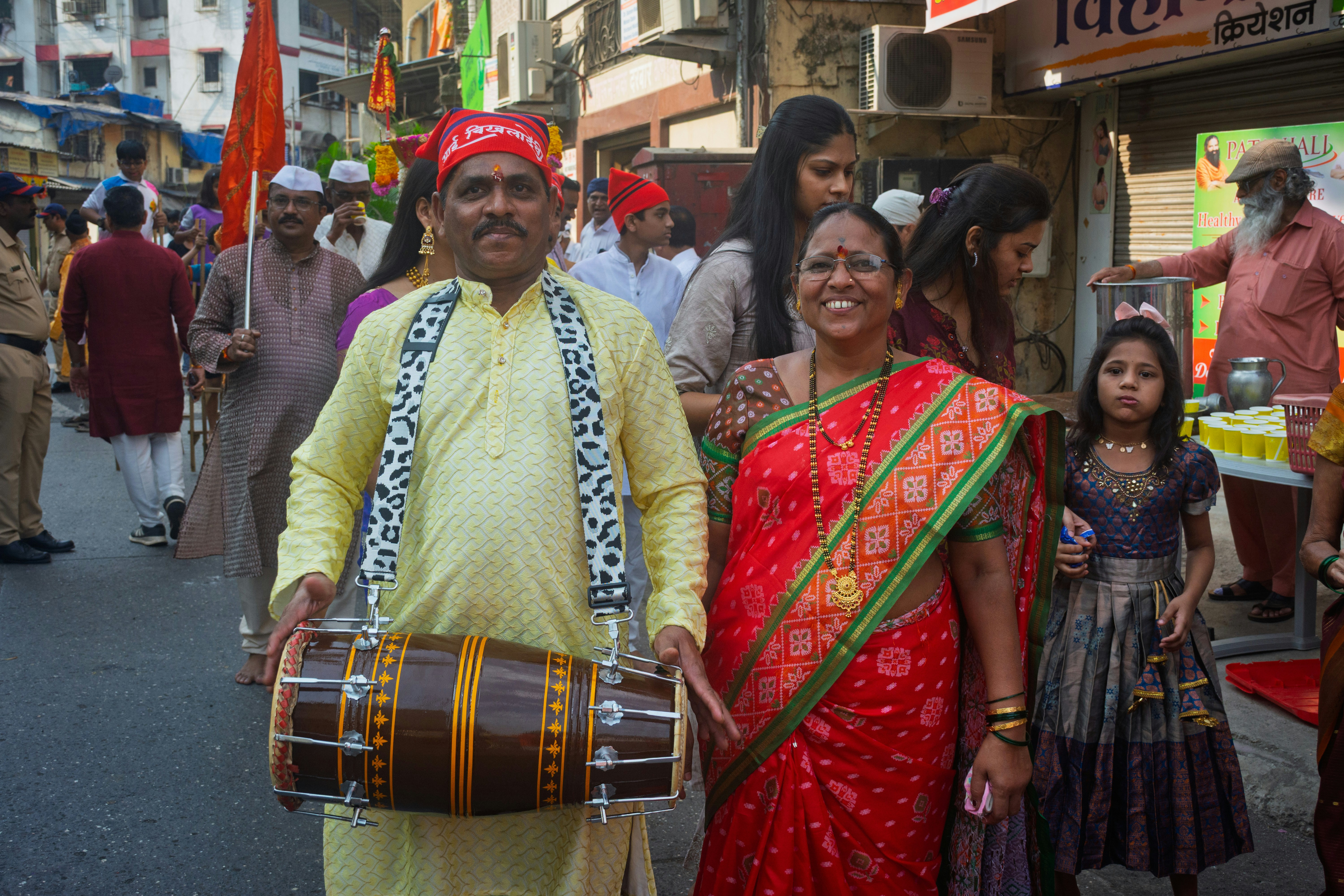 A dhol drummer in a village procession