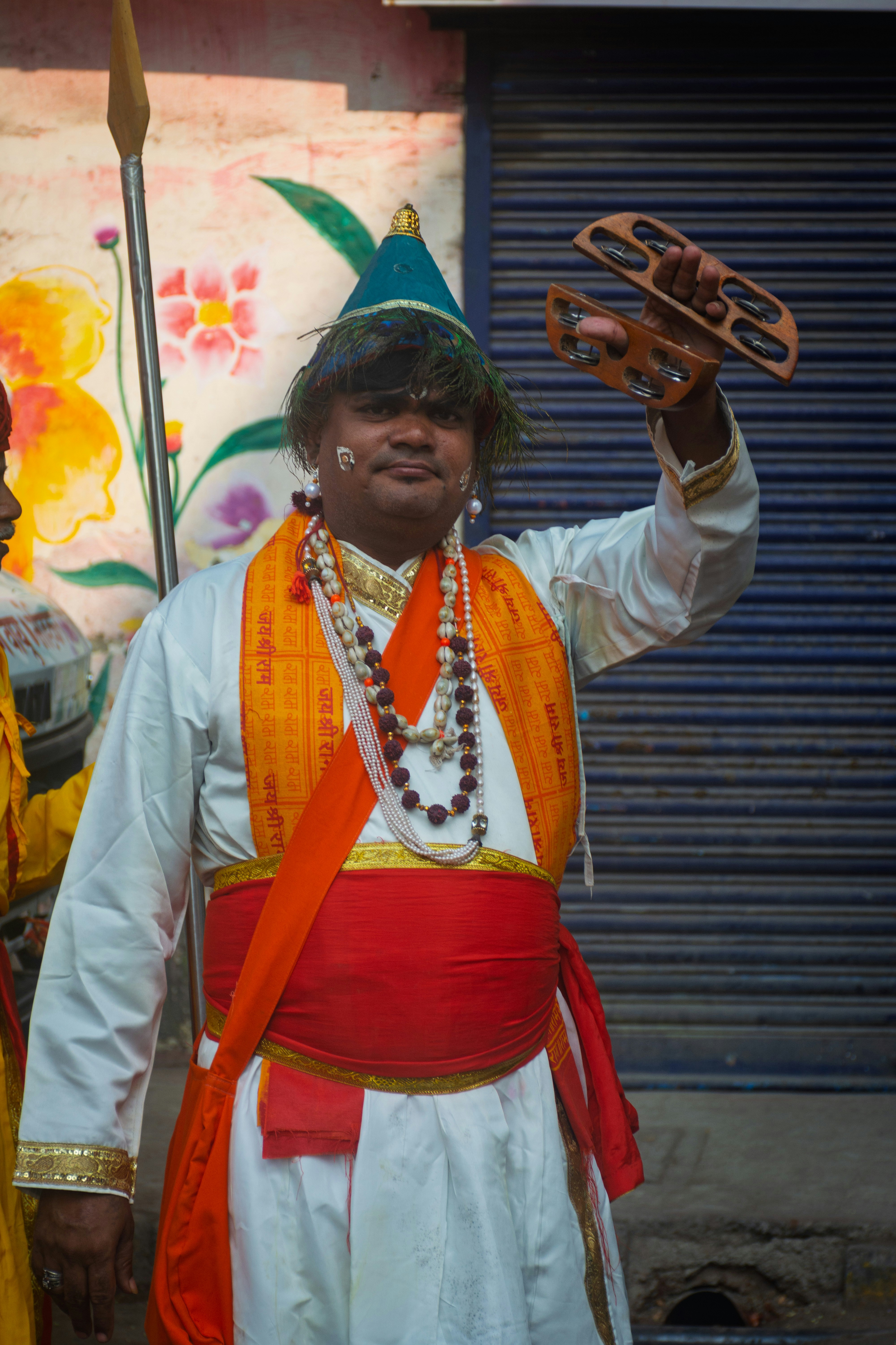 Man in traditional costume playing tambourine