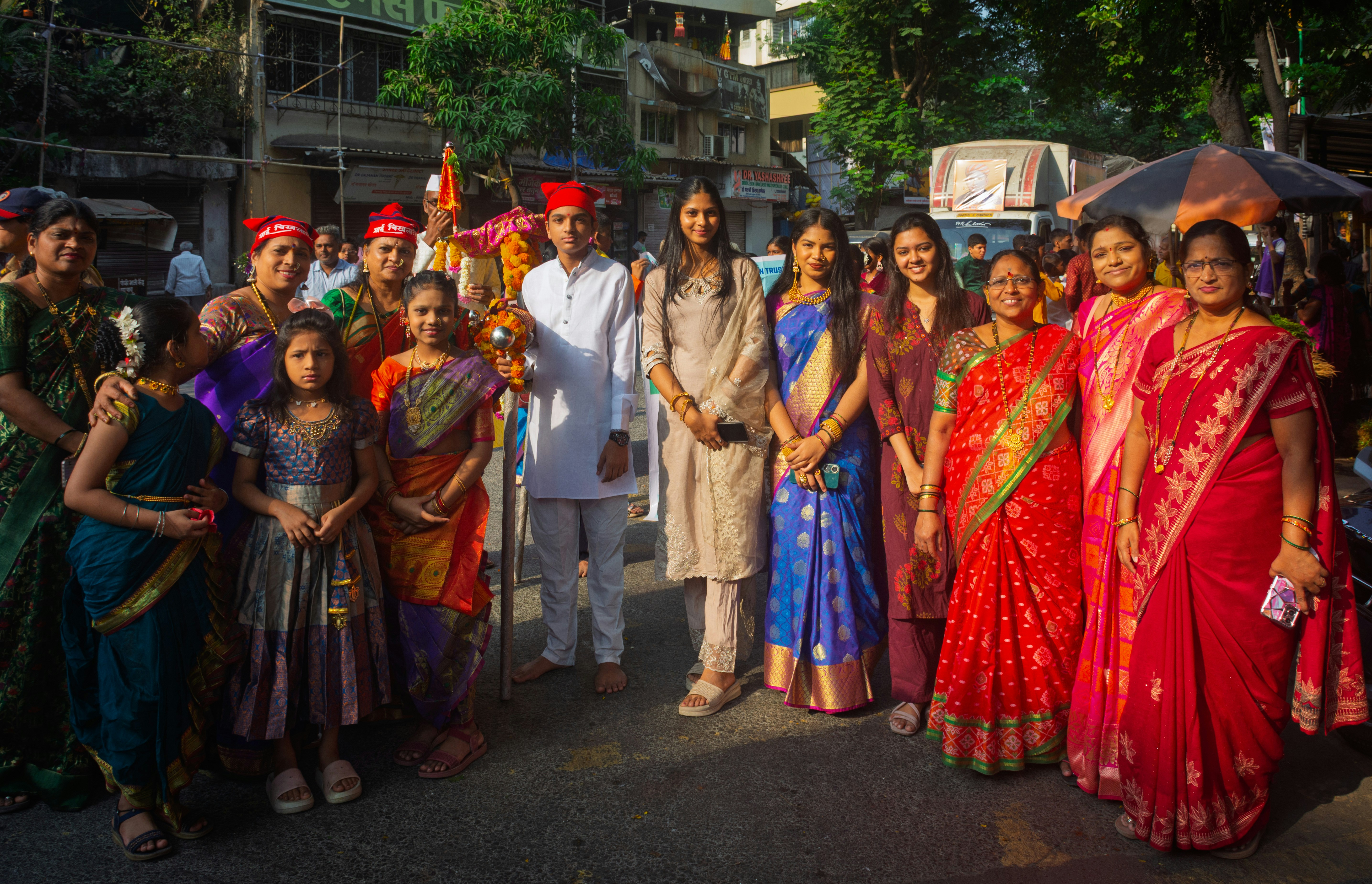A family sitting together, perhaps watching news on TV, looking concerned. The background subtly shows a bustling market with slightly higher prices on goods.