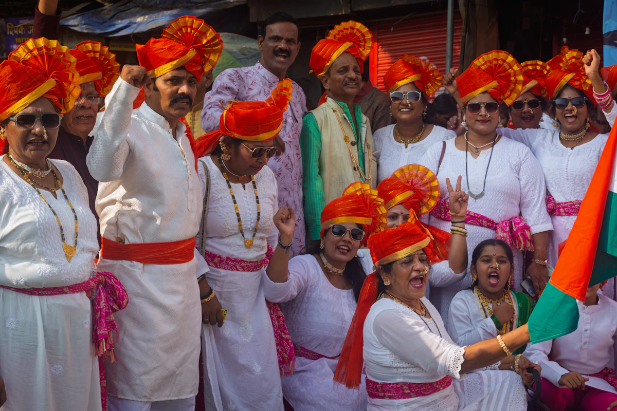Group of people in orange turbans and white clothing celebrating Independence Day in India
