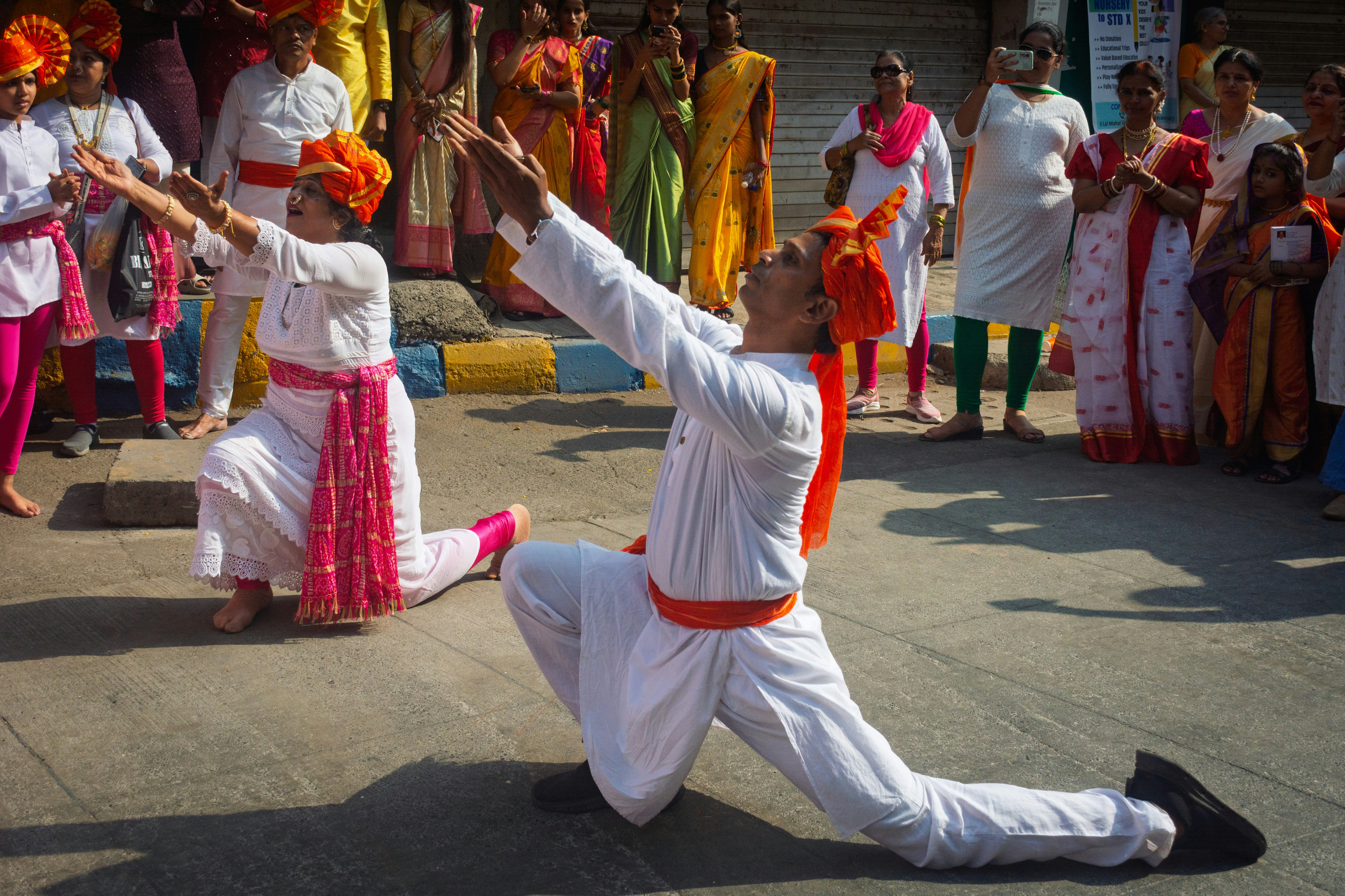 Two people in traditional attire performing a dance