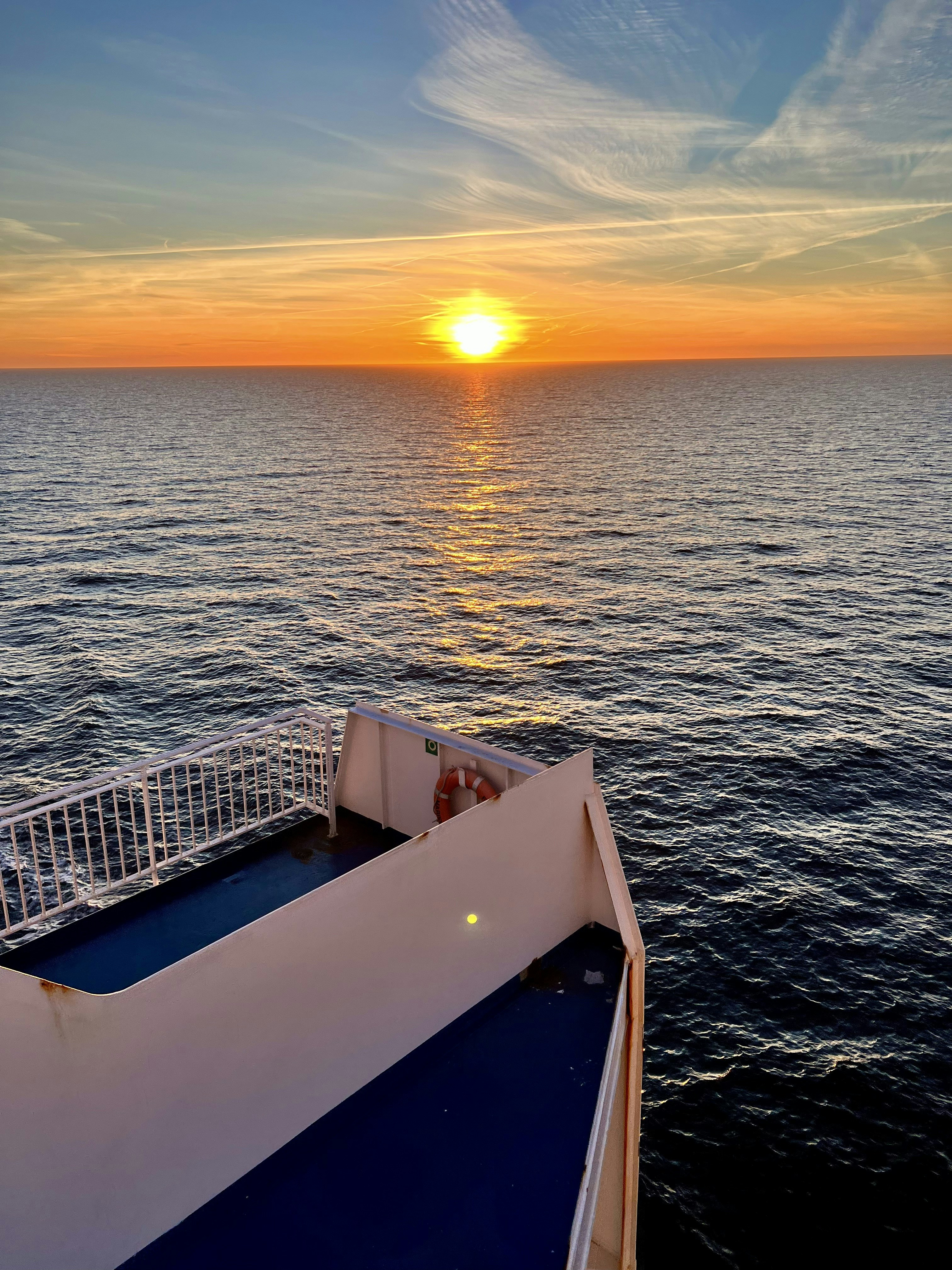 Sunset over the ocean from a ferry deck