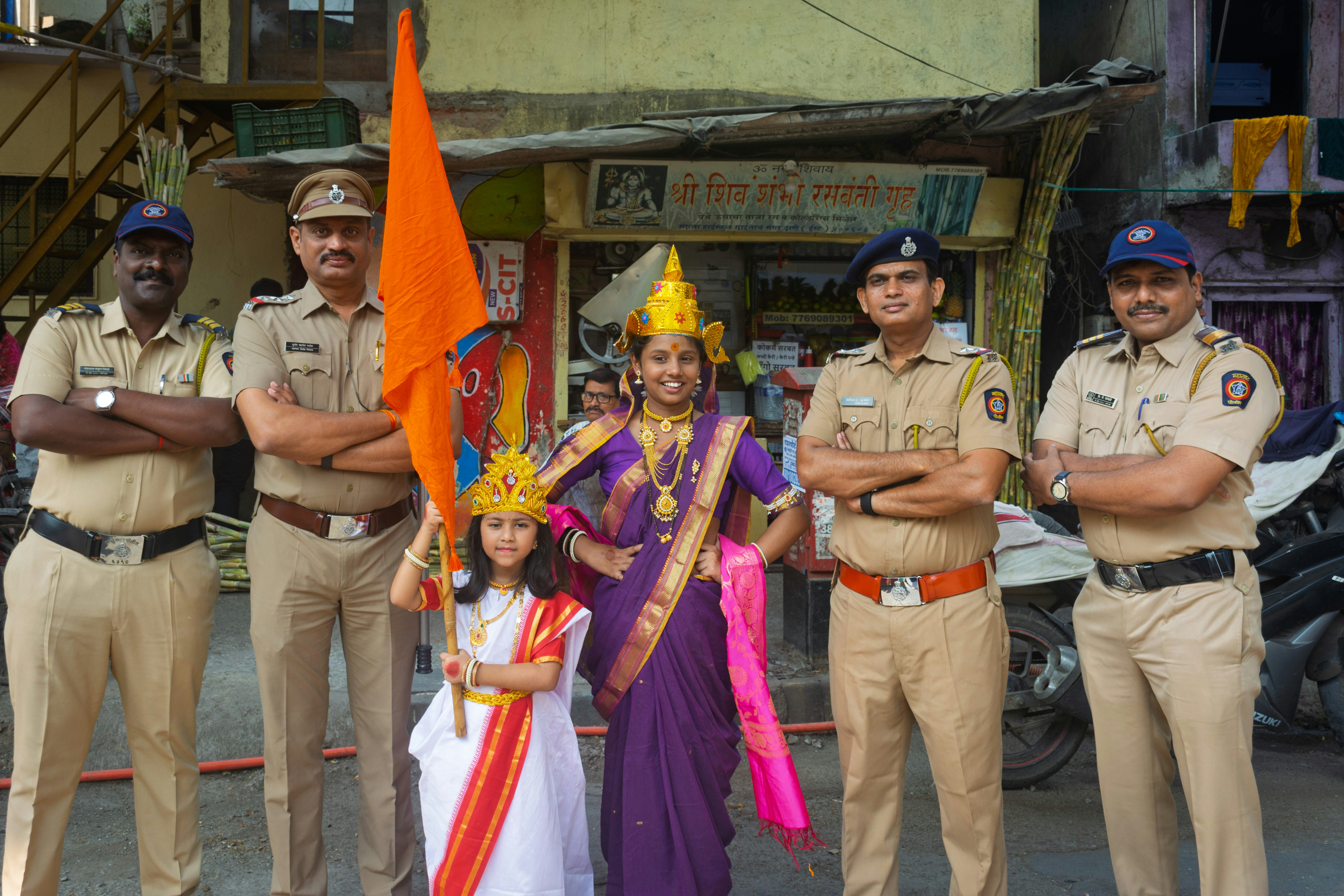 Police officers with women in cultural attire