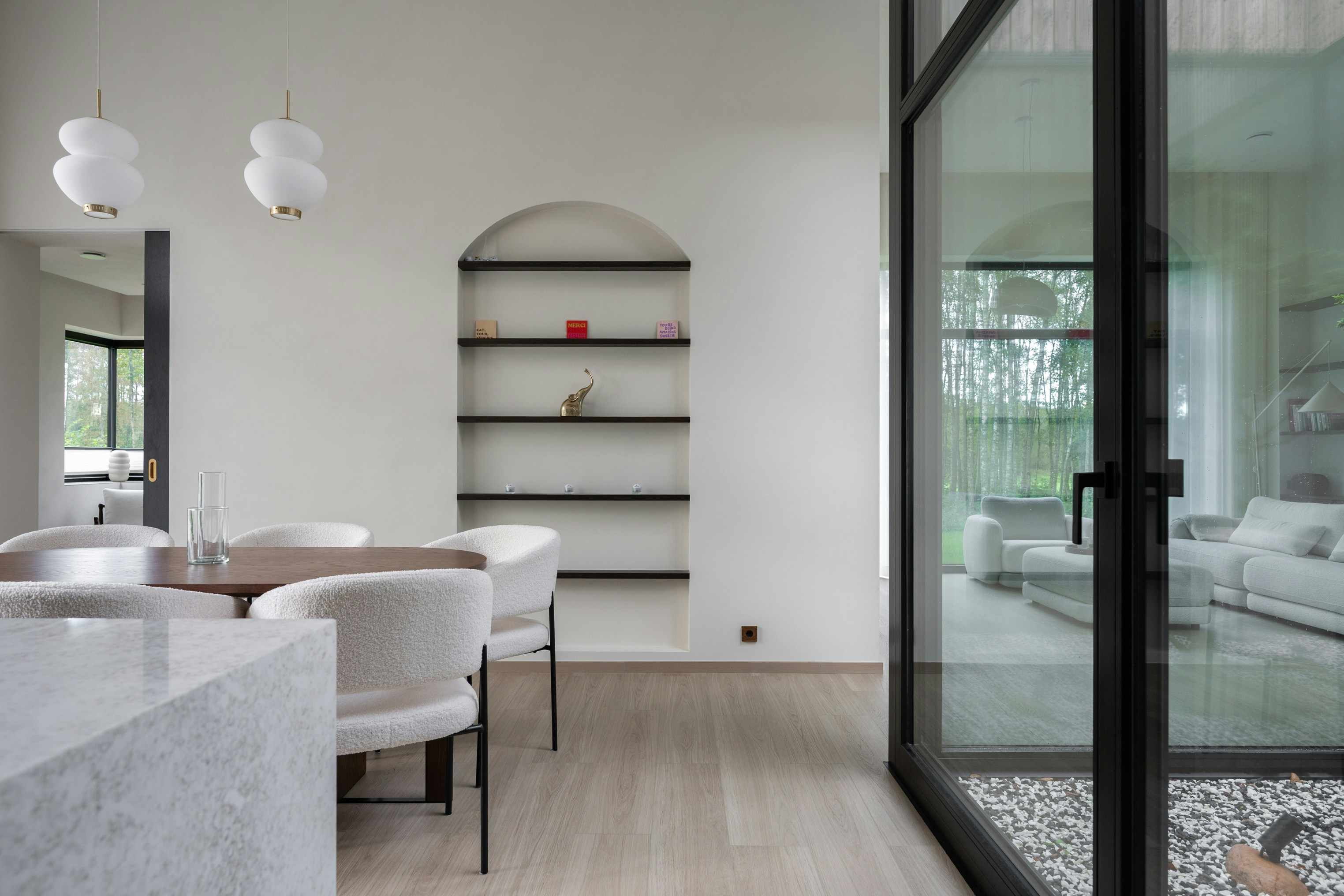 Modern dining room with arched shelves and large windows