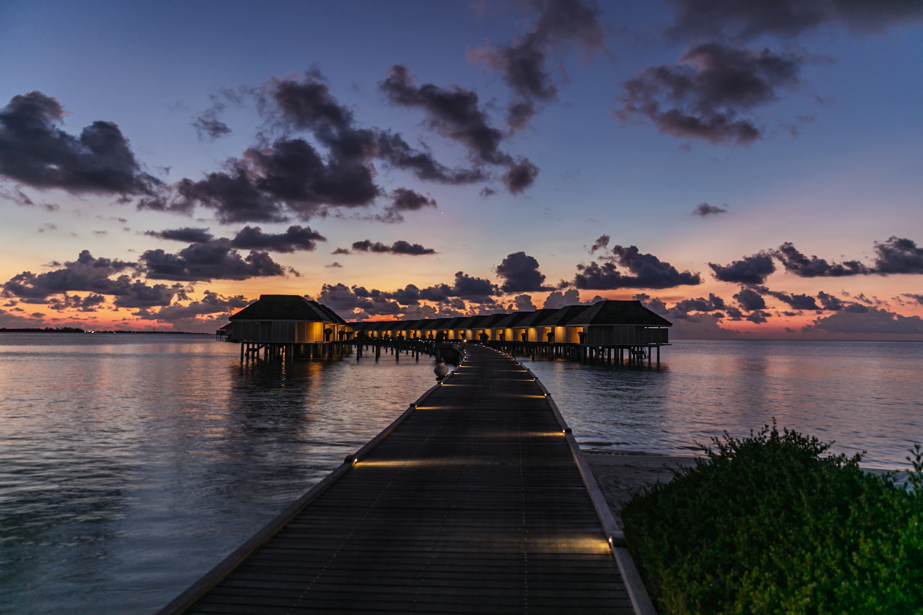 Overwater bungalows at dusk