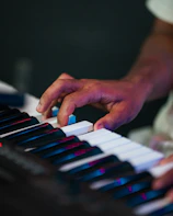 Close-up of a person's hands playing a keyboard