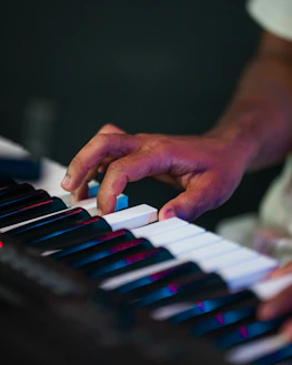 Close-up of a person's hands playing a keyboard