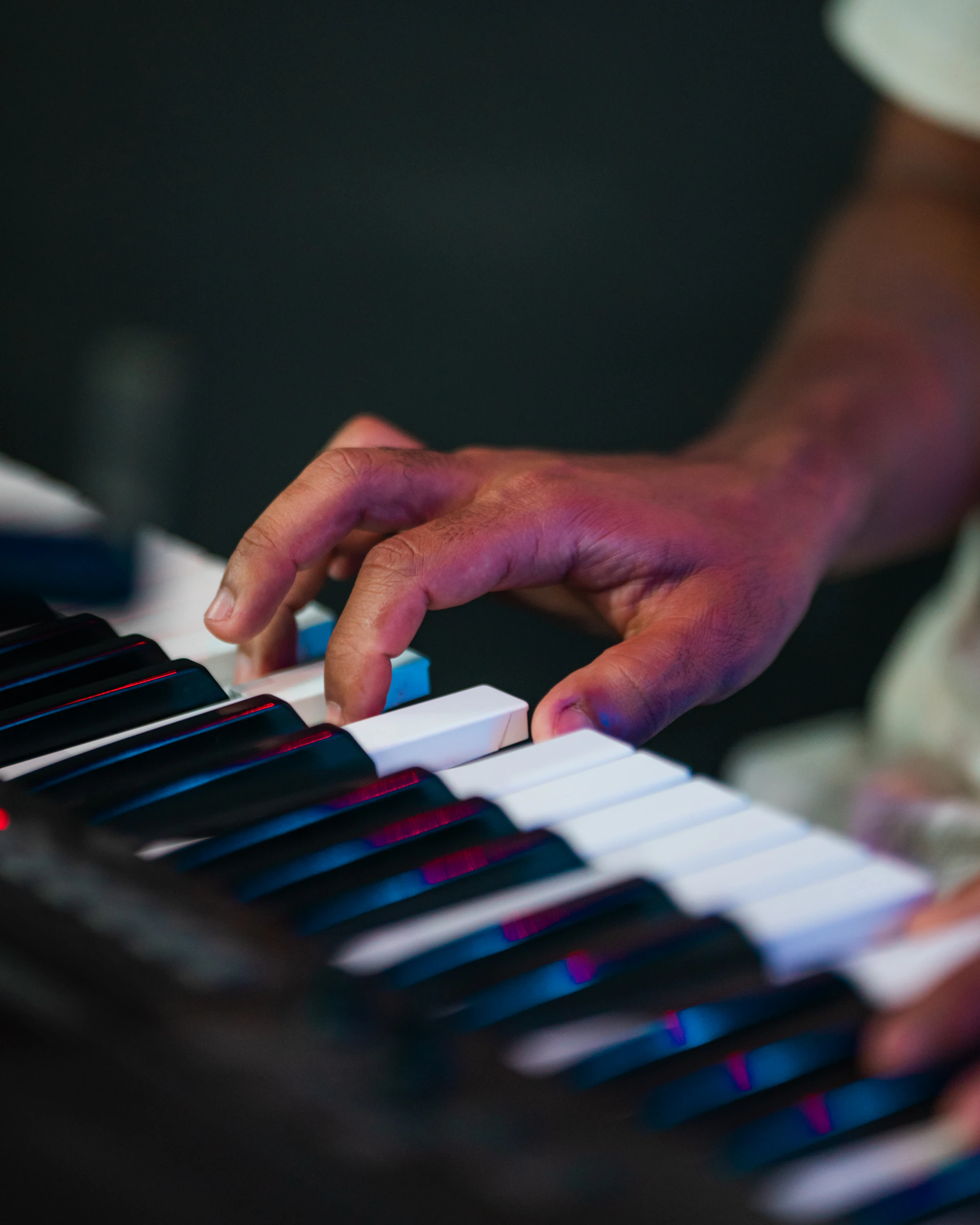 Close-up of a person's hands playing a keyboard