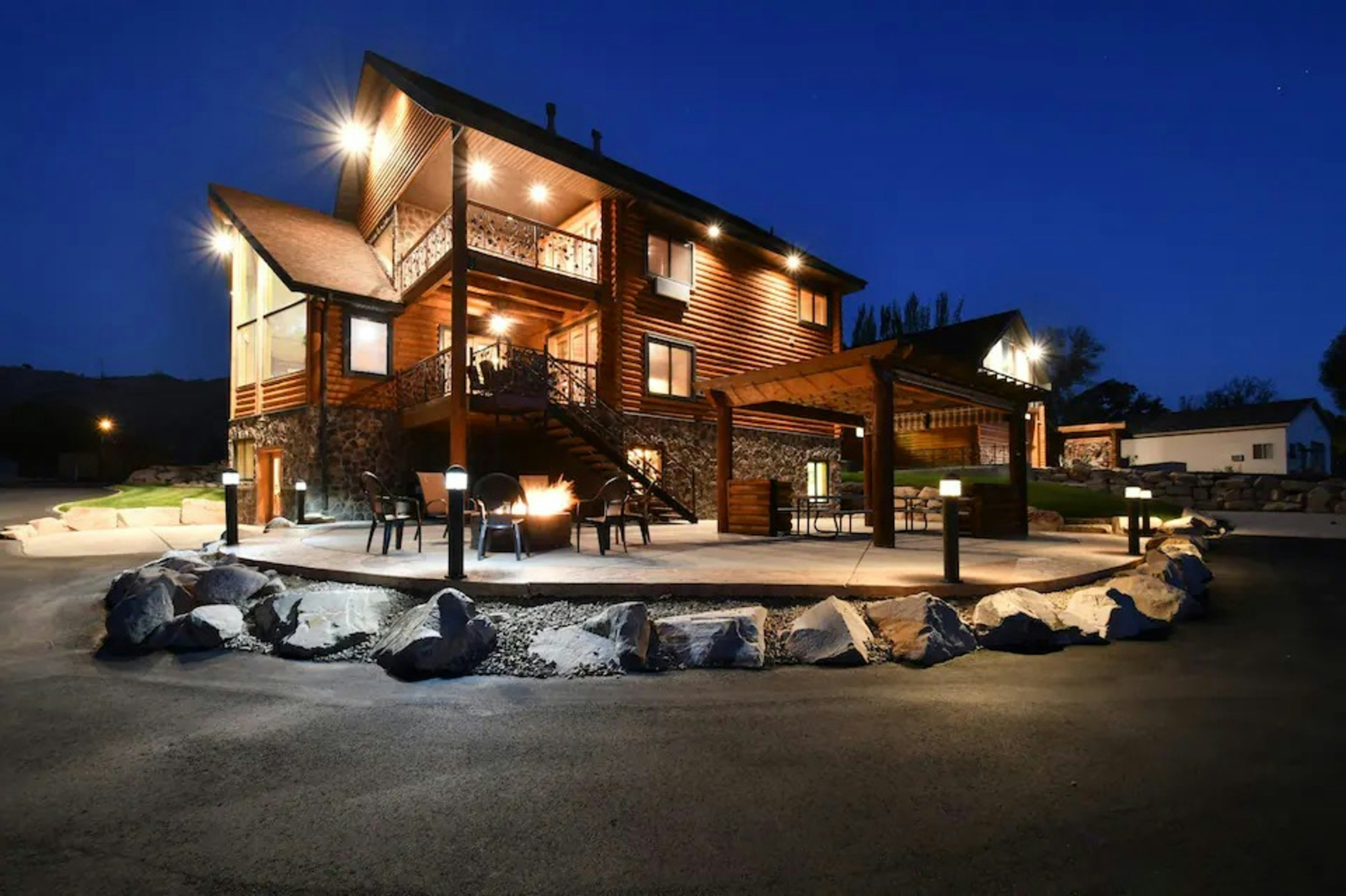 Modern wooden house with outdoor seating at night