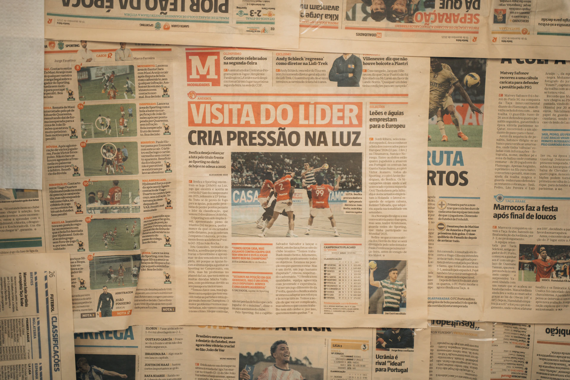 Newspaper headlines and articles displayed on a wall.