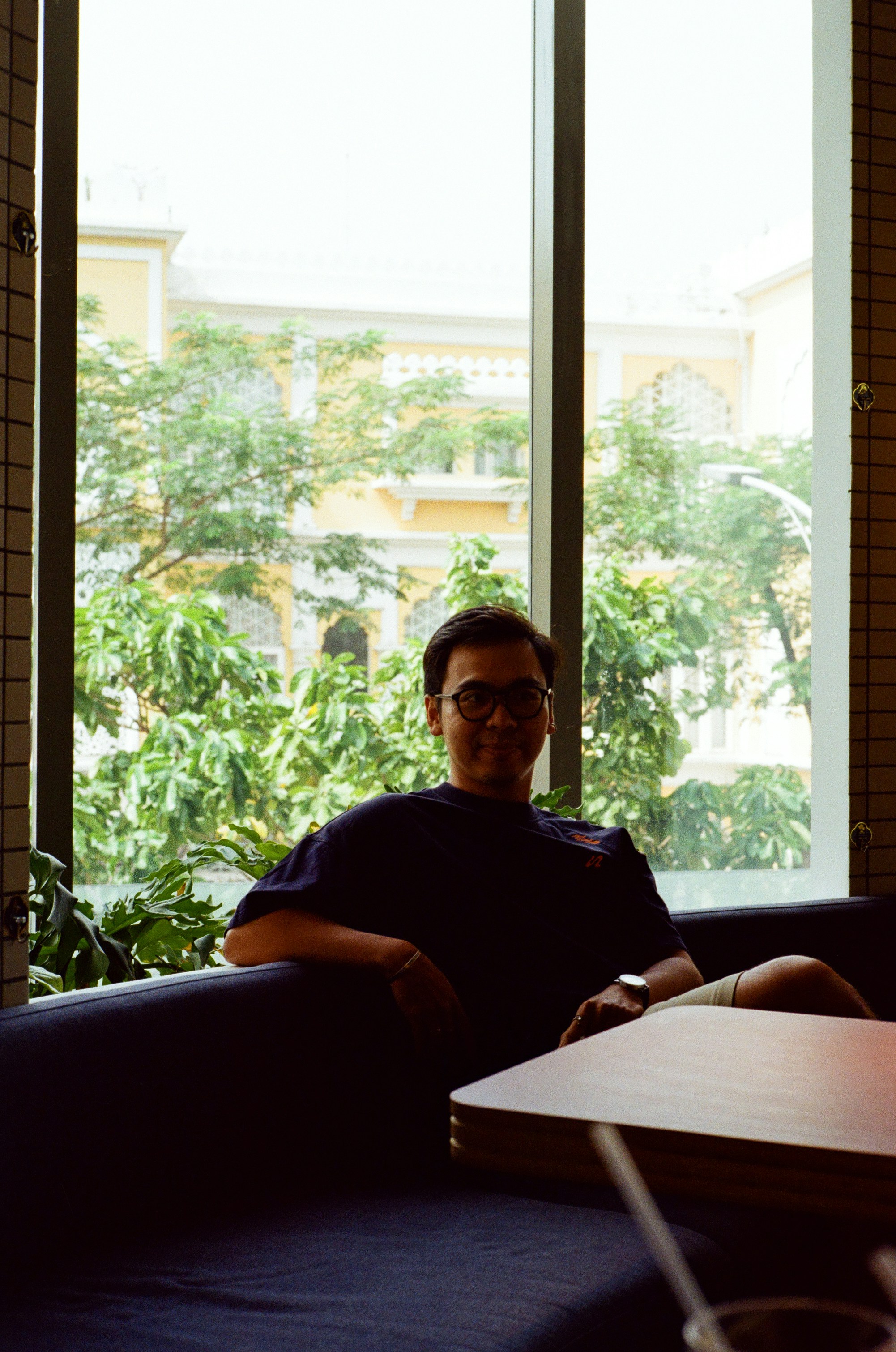 Man sitting on a couch by the window